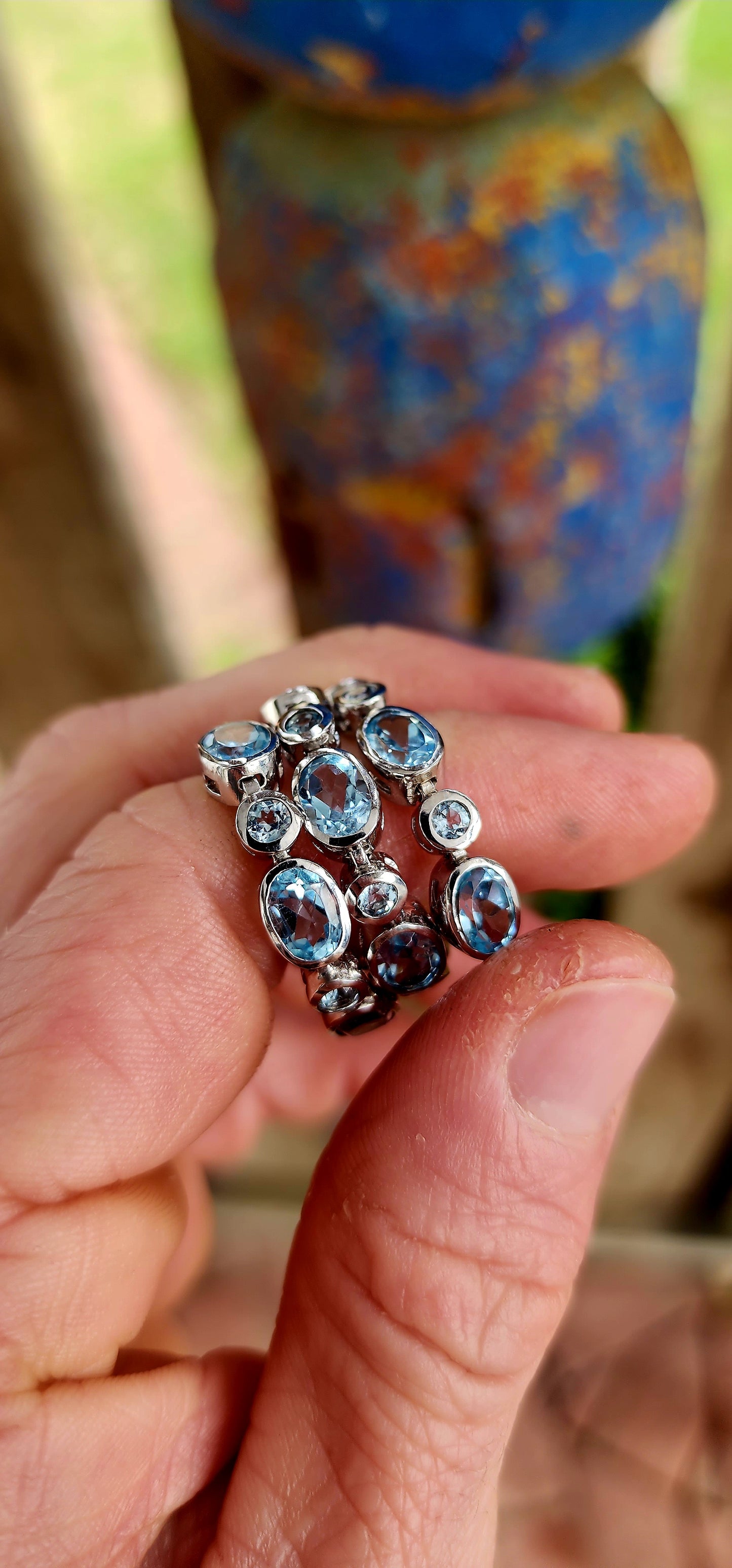 This dazzling bracelet is crafted in polished sterling silver, showcasing a graceful row of 24x sky blue topaz gemstones, each securely nestled in sleek tube bezel settings.