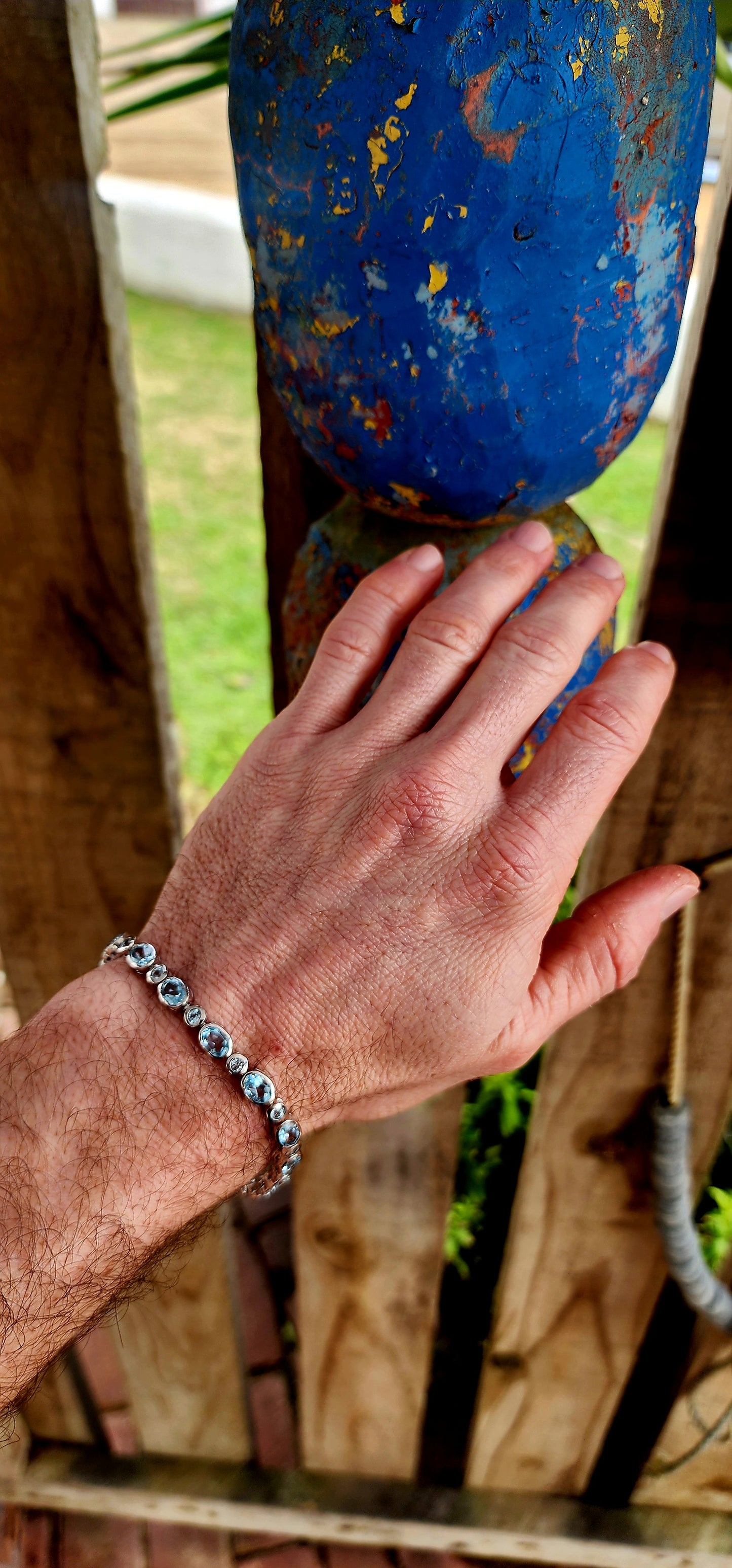This dazzling bracelet is crafted in polished sterling silver, showcasing a graceful row of 24x sky blue topaz gemstones, each securely nestled in sleek tube bezel settings.