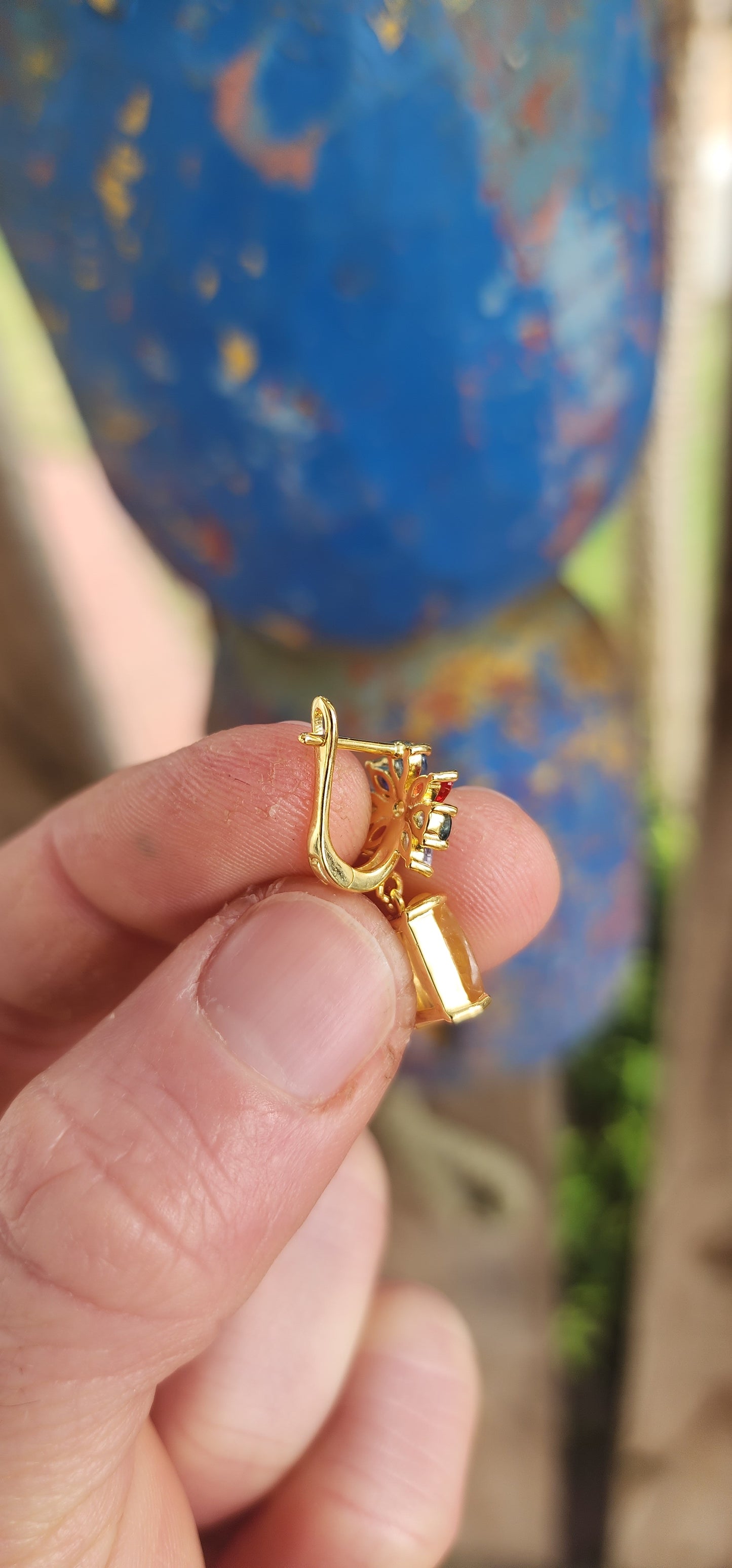 Fairytale Blossoms in Golden Light.
Crafted in sterling silver and plated in luxurious 18ct yellow gold, each earring begins with a radiant floral bloom, lovingly composed of colorful sapphires in playful pear and marquise cuts.