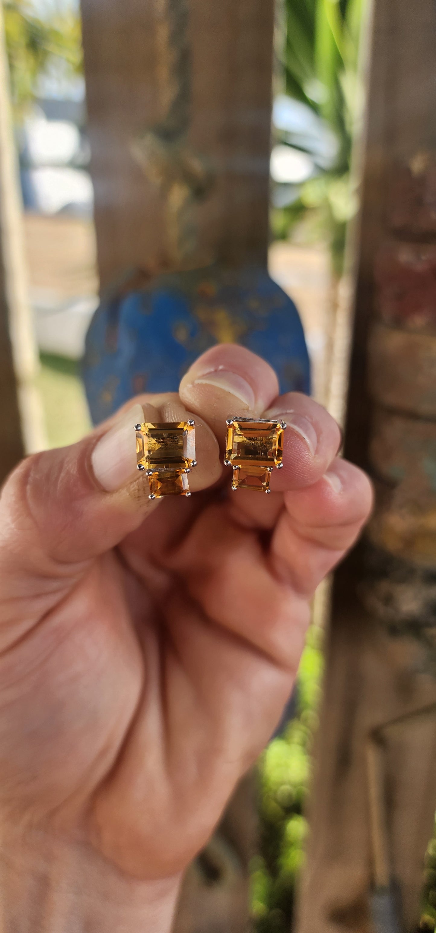 Elegant and versatile, this pair of sterling silver stud earrings brings golden warmth to your look. Each earring features two richly hued emerald-cut citrine gemstones.