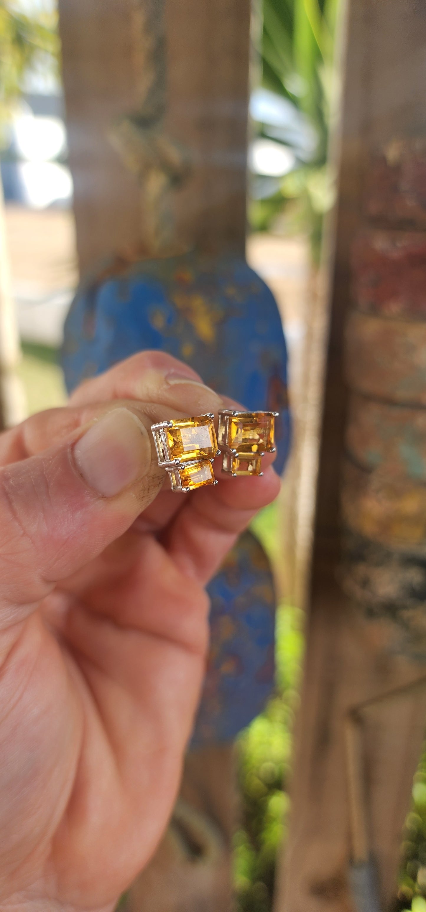 Elegant and versatile, this pair of sterling silver stud earrings brings golden warmth to your look. Each earring features two richly hued emerald-cut citrine gemstones.