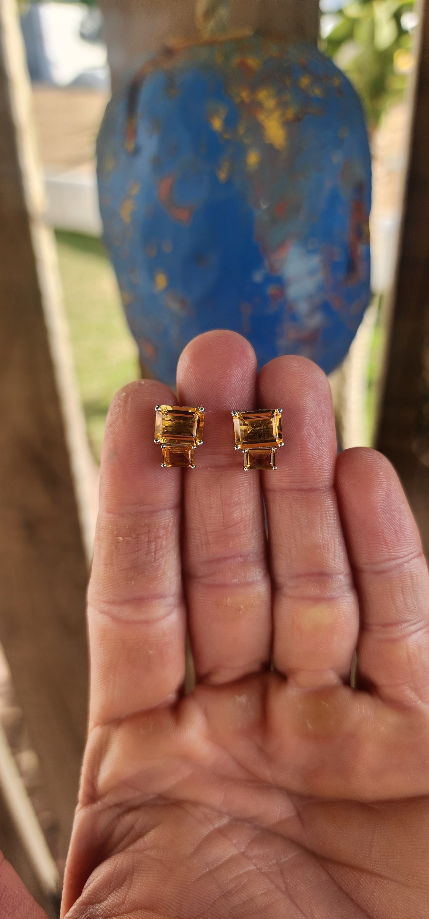Elegant and versatile, this pair of sterling silver stud earrings brings golden warmth to your look. Each earring features two richly hued emerald-cut citrine gemstones.