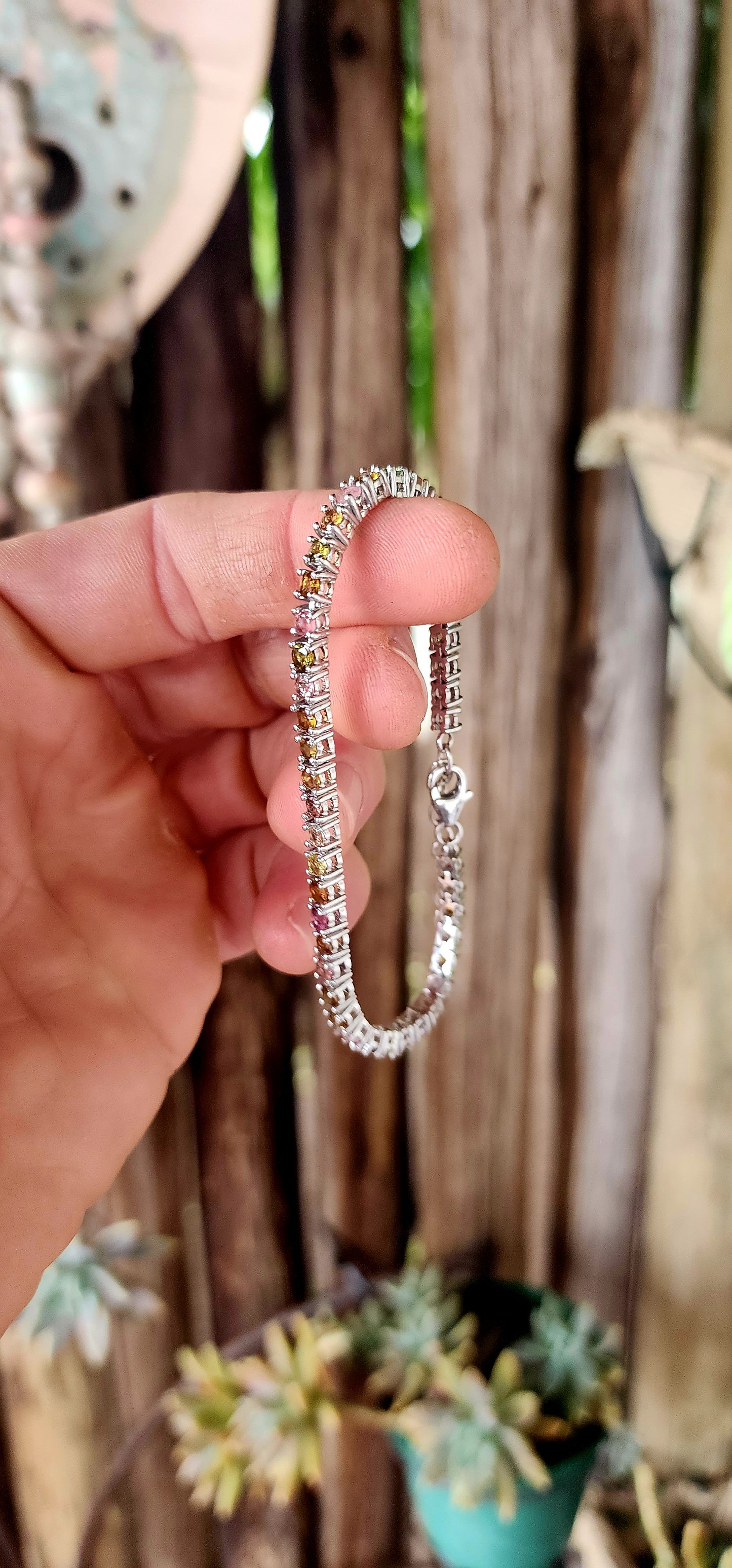 Meet the bracelet that refuses to pick a favorite color! This sleek sterling silver tennis-style beauty lines up 43 round-cut tourmaline gemstones in a dazzling spectrum—from leafy greens and golden ambers to bubblegum pinks and raspberry reds.