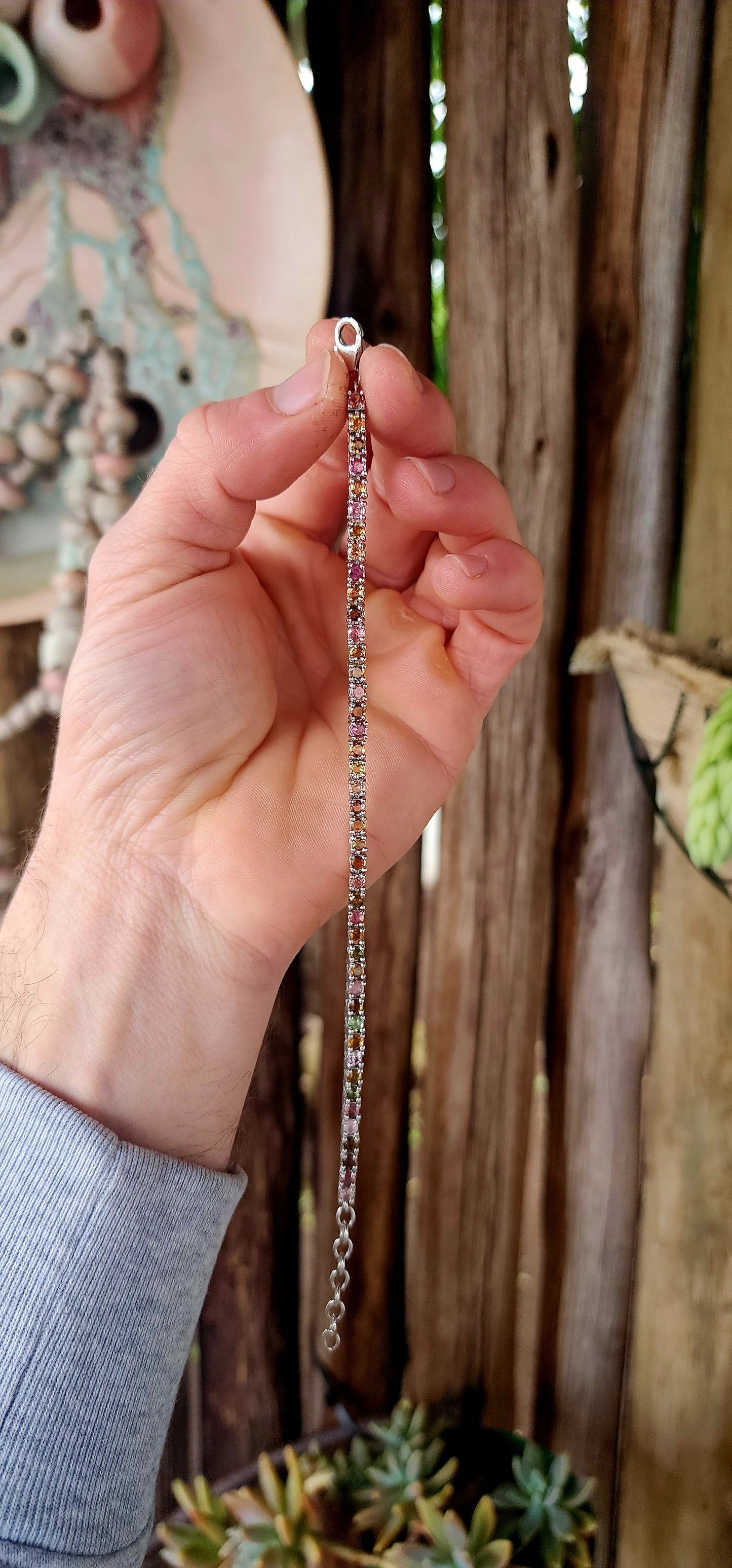 Meet the bracelet that refuses to pick a favorite color! This sleek sterling silver tennis-style beauty lines up 43 round-cut tourmaline gemstones in a dazzling spectrum—from leafy greens and golden ambers to bubblegum pinks and raspberry reds.