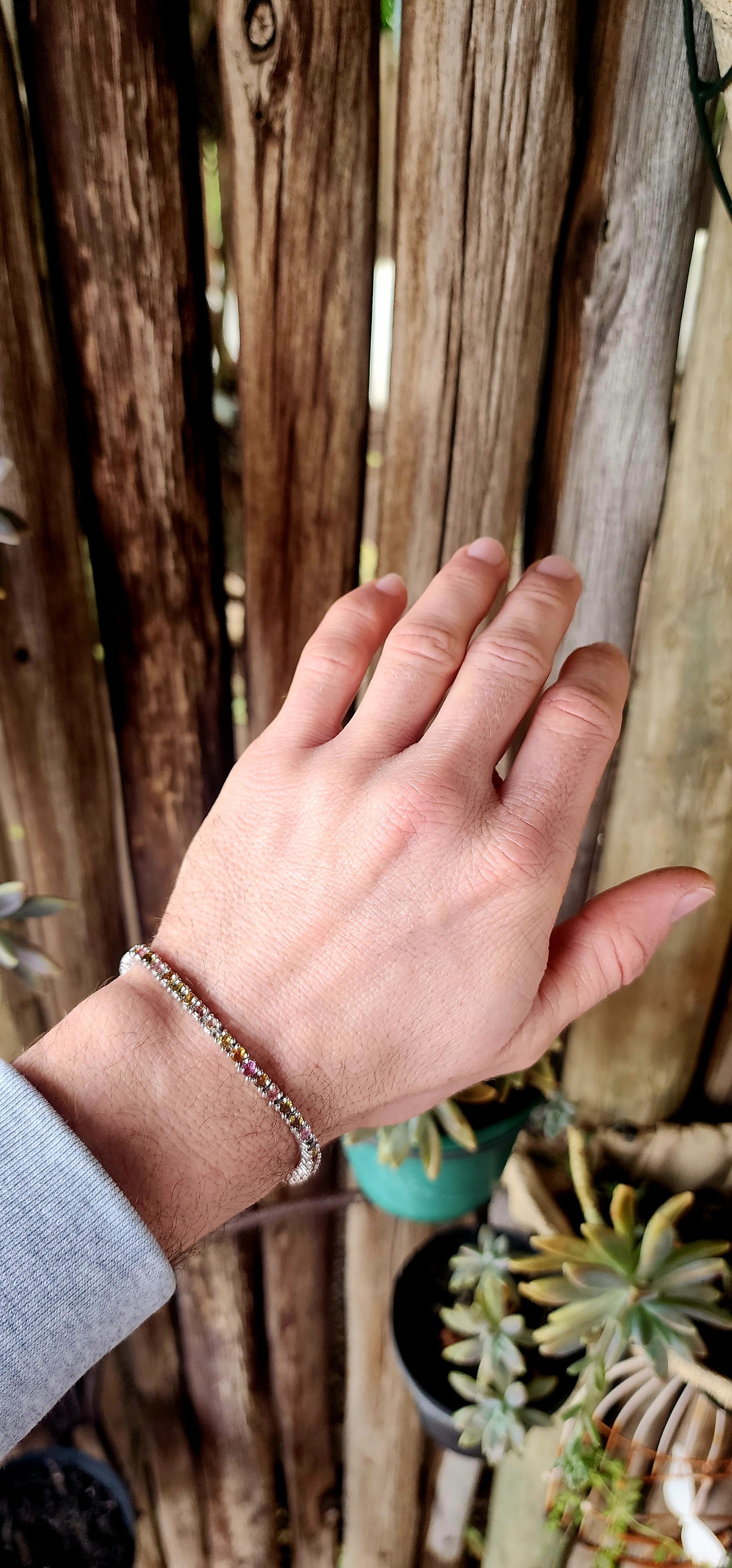 Meet the bracelet that refuses to pick a favorite color! This sleek sterling silver tennis-style beauty lines up 43 round-cut tourmaline gemstones in a dazzling spectrum—from leafy greens and golden ambers to bubblegum pinks and raspberry reds.