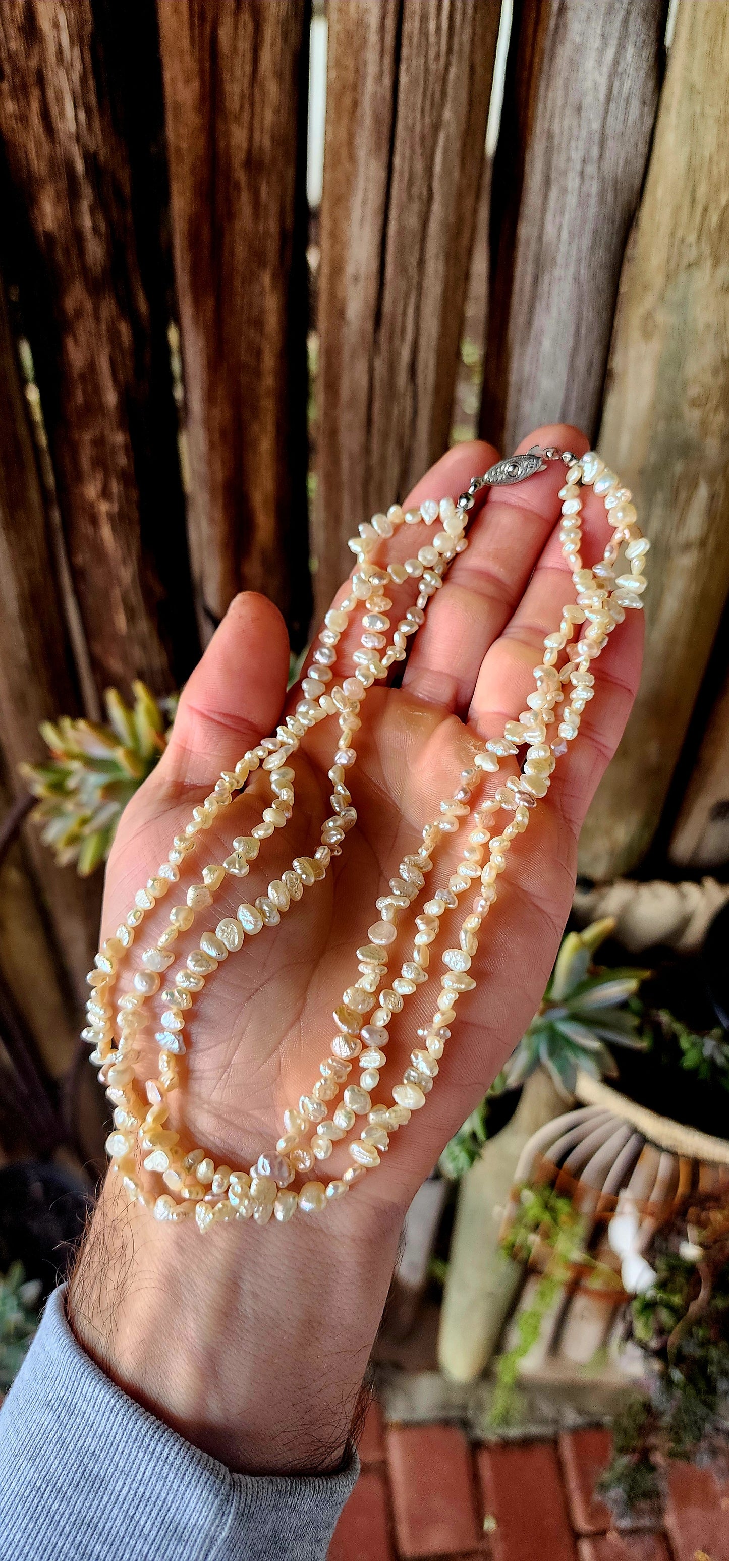 This beautiful vintage art deco era necklace showcases three strands of luminous freshwater keshi rice pearls, each with its own unique, organic shape.