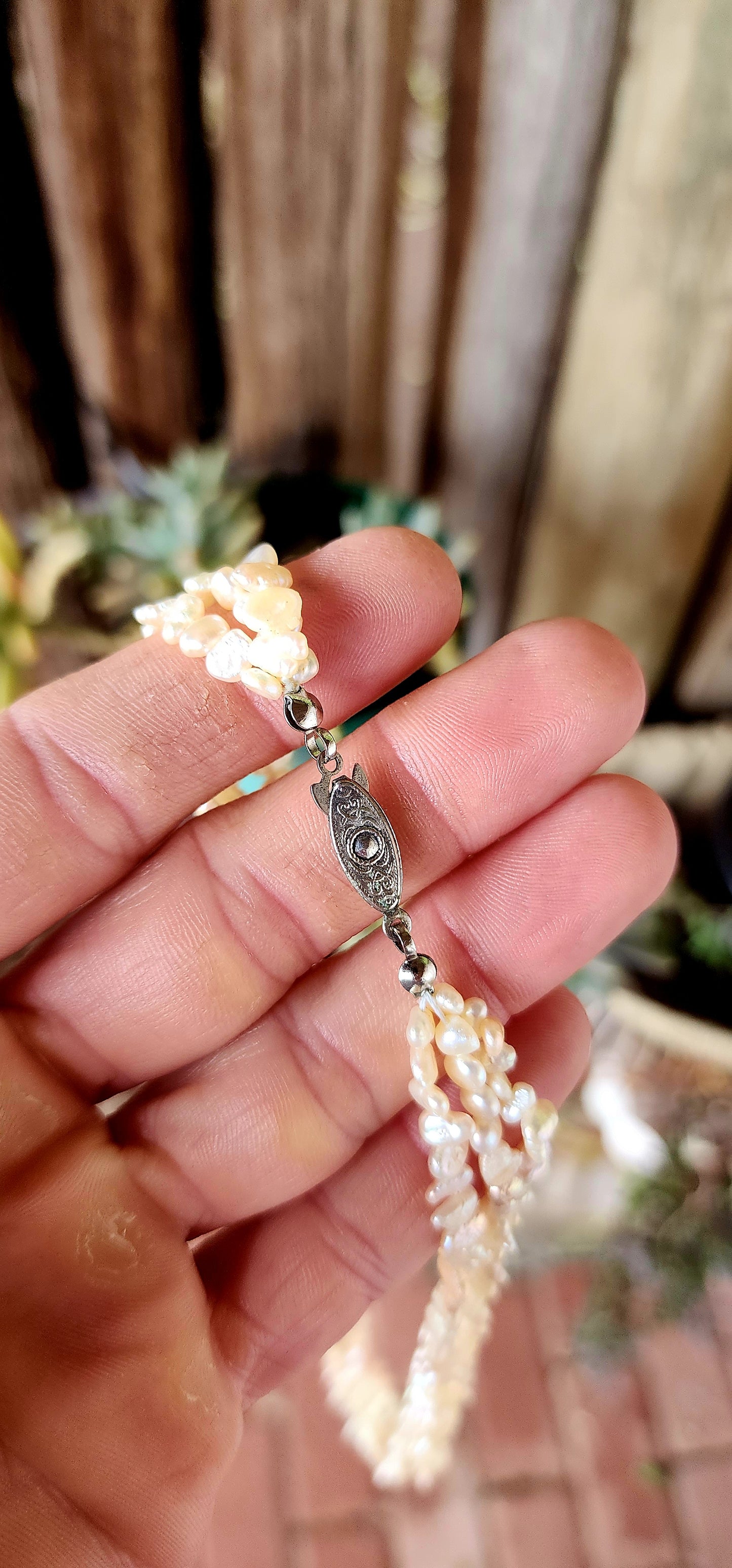 This beautiful vintage art deco era necklace showcases three strands of luminous freshwater keshi rice pearls, each with its own unique, organic shape.
