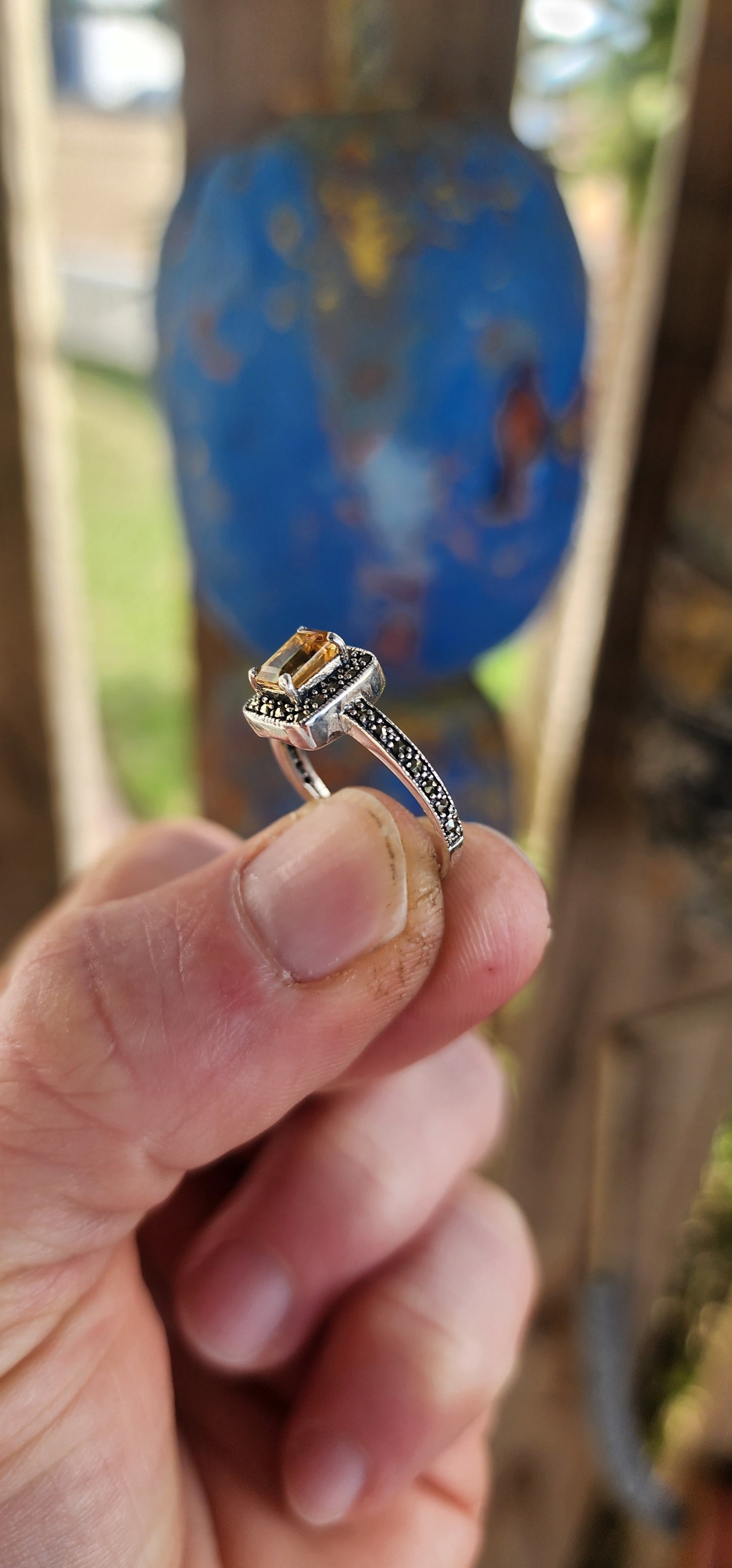This sterling silver halo ring is crafted in a vintage Art Deco style that beautifully blends geometric precision with old-world charm.