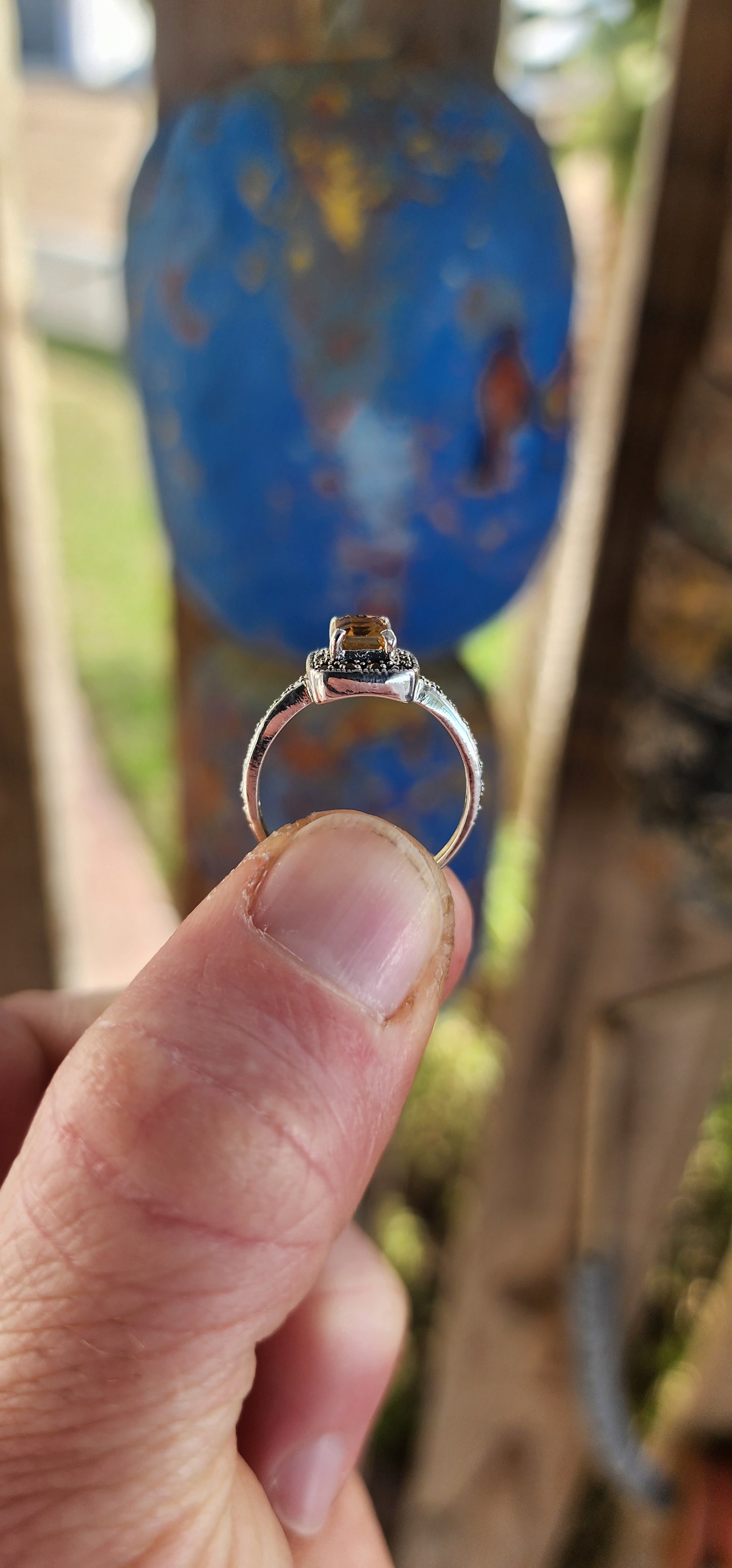 This sterling silver halo ring is crafted in a vintage Art Deco style that beautifully blends geometric precision with old-world charm.