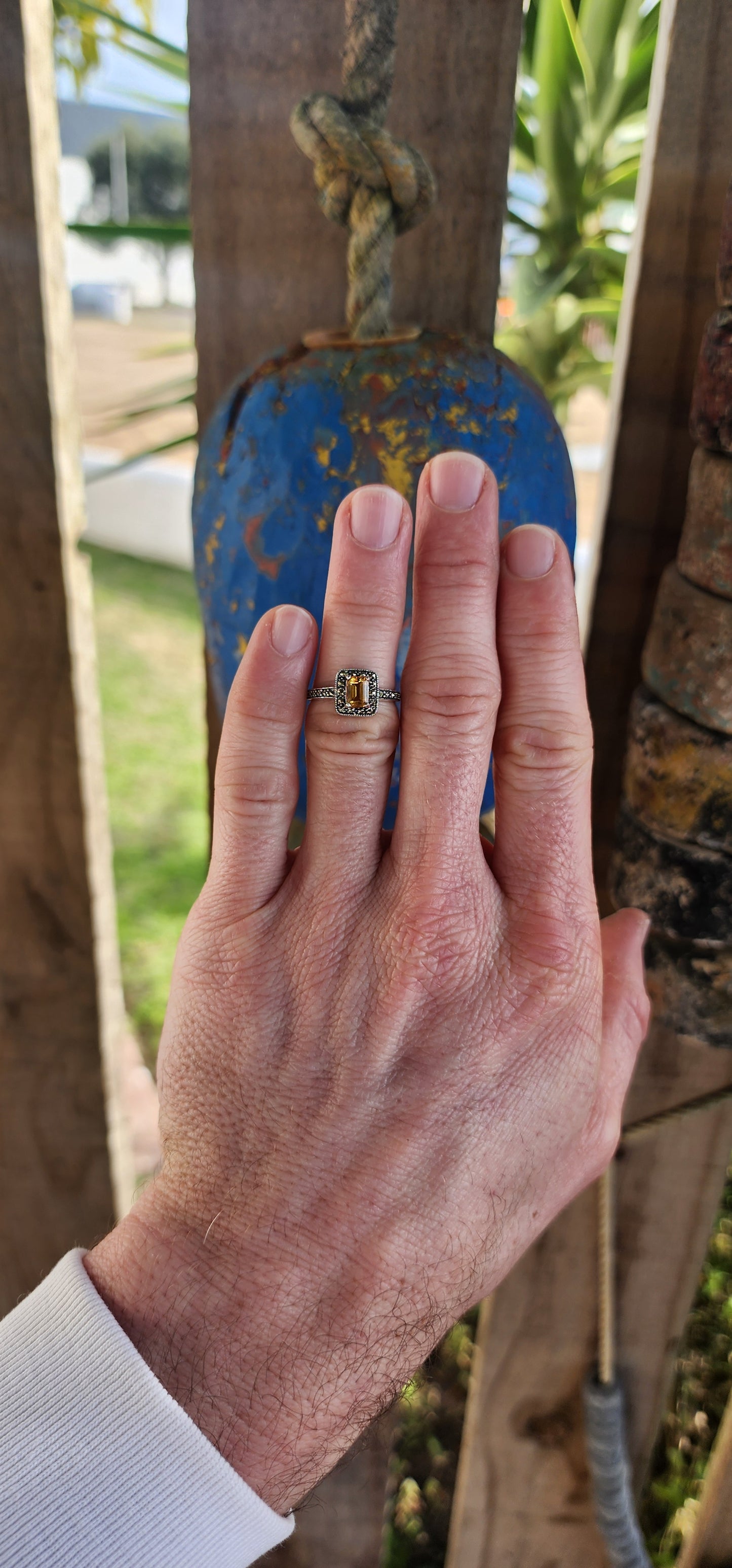 This sterling silver halo ring is crafted in a vintage Art Deco style that beautifully blends geometric precision with old-world charm.