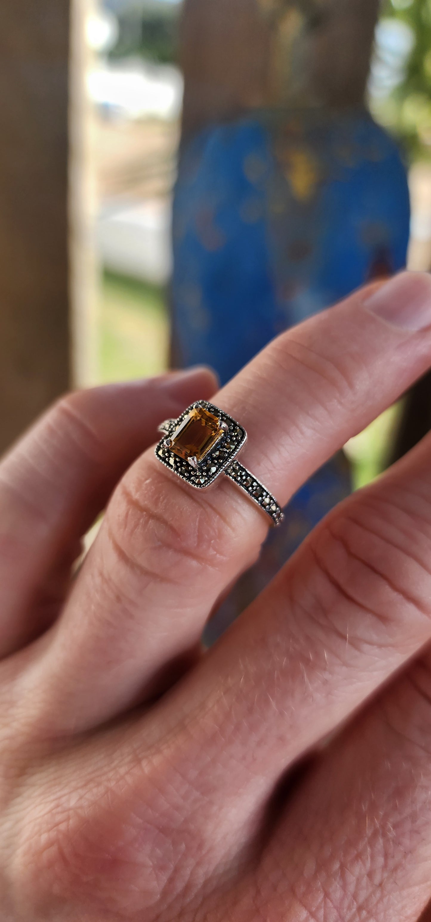 This sterling silver halo ring is crafted in a vintage Art Deco style that beautifully blends geometric precision with old-world charm.
