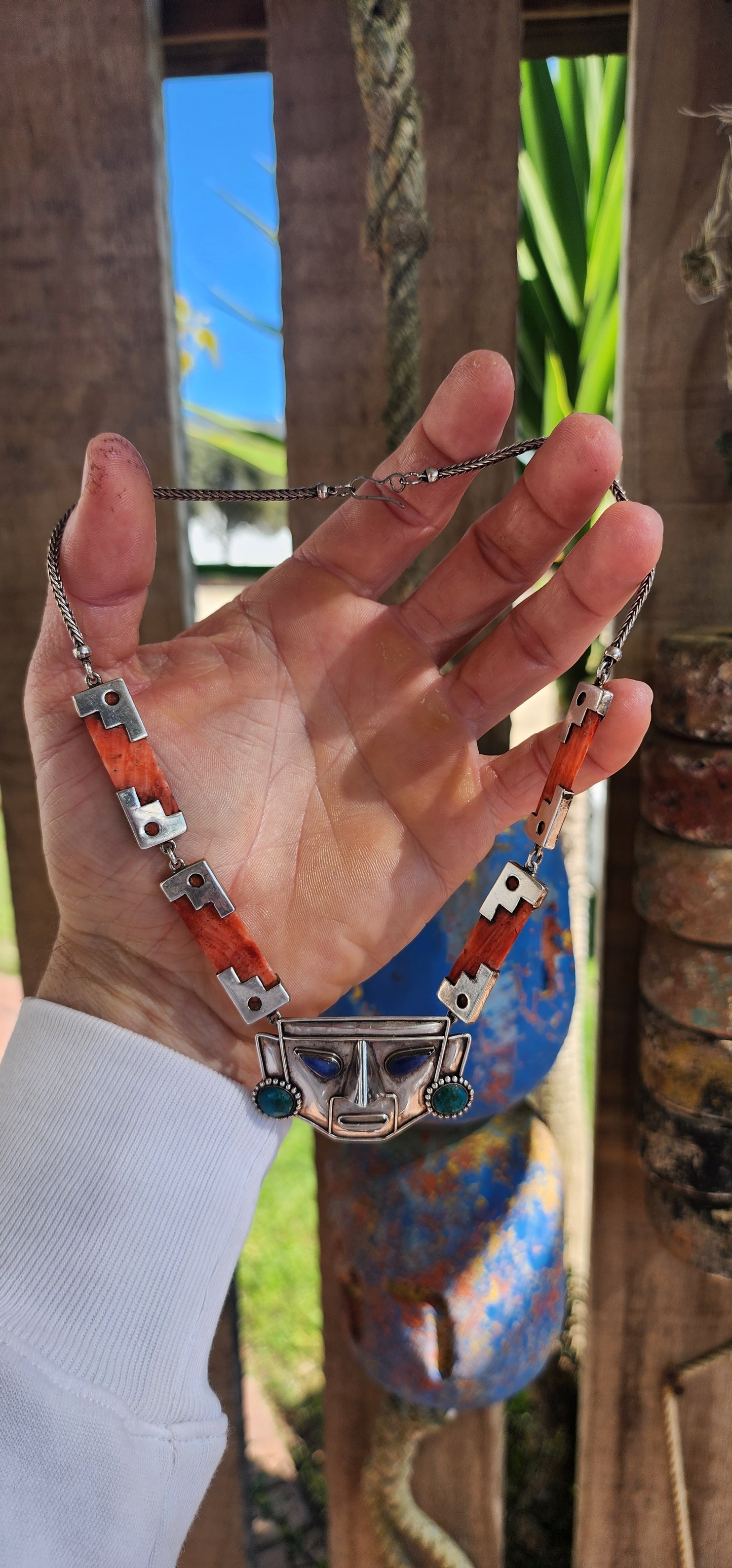 This striking vintage necklace is a true celebration of Andean artistry and cultural symbolism. Crafted in sterling silver, it features a bold central pendant in the form of an Incan-inspired mask.