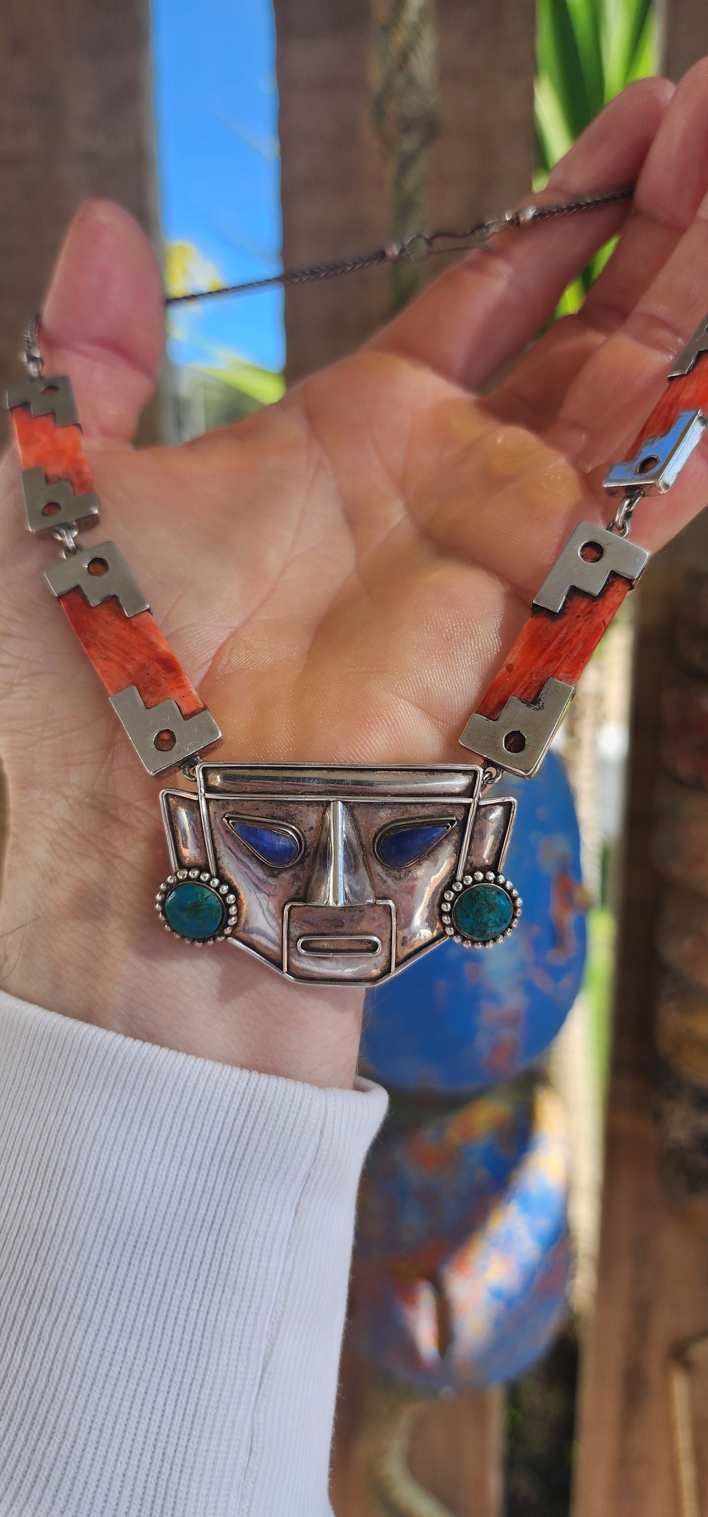 This striking vintage necklace is a true celebration of Andean artistry and cultural symbolism. Crafted in sterling silver, it features a bold central pendant in the form of an Incan-inspired mask.