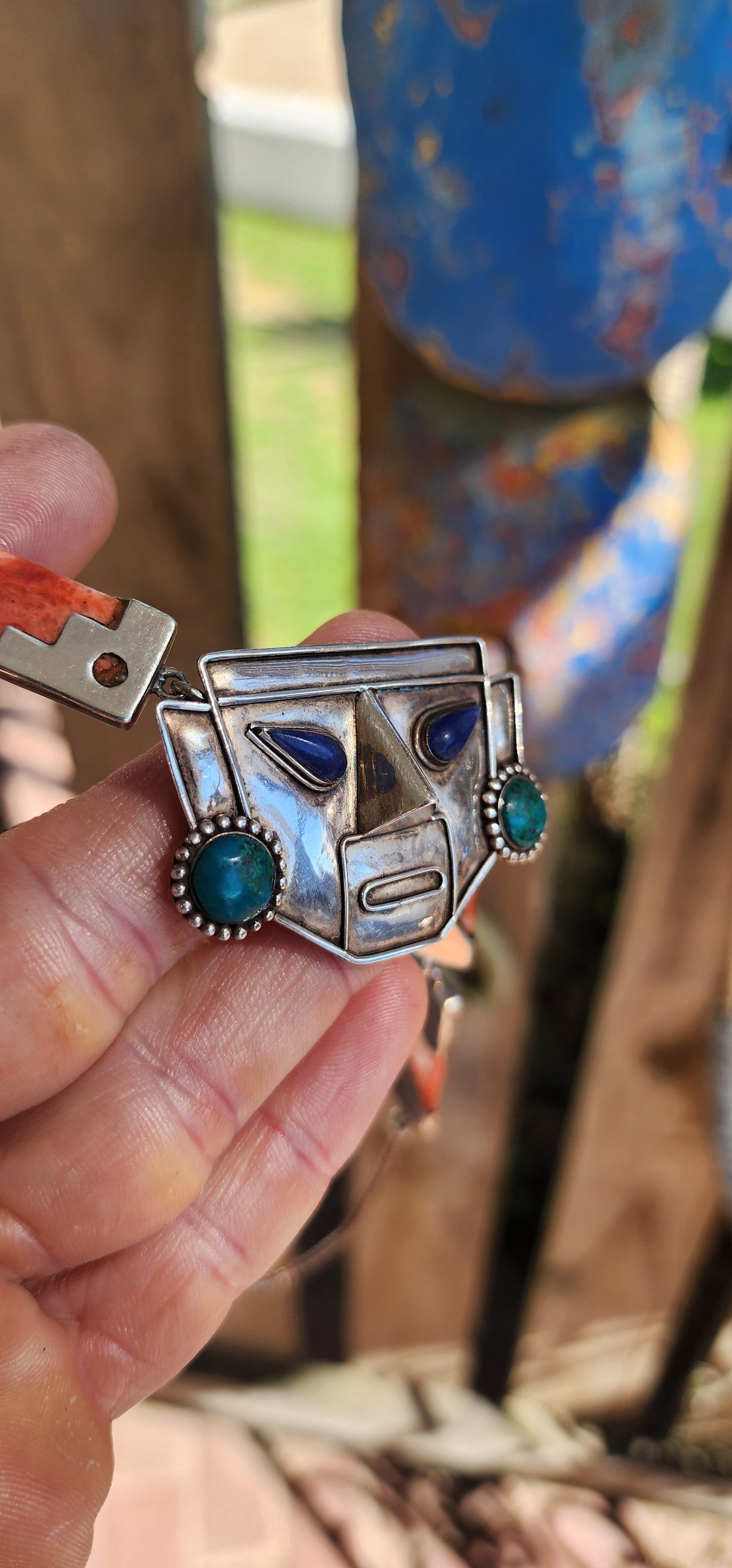 This striking vintage necklace is a true celebration of Andean artistry and cultural symbolism. Crafted in sterling silver, it features a bold central pendant in the form of an Incan-inspired mask.