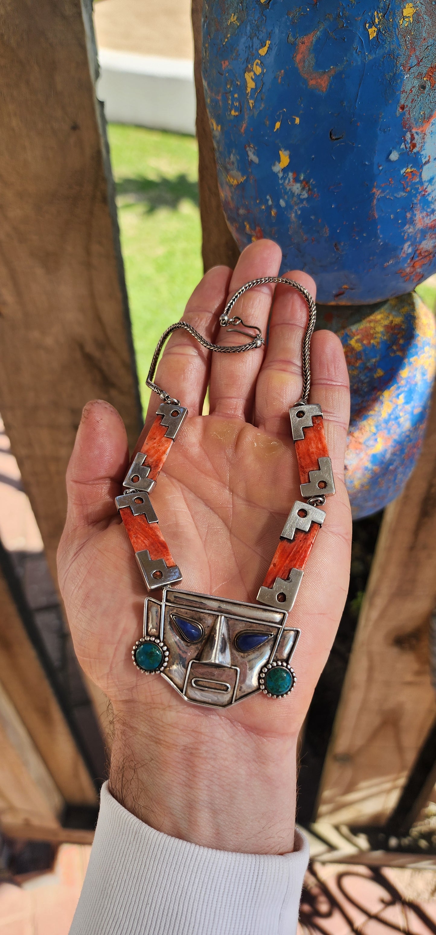 This striking vintage necklace is a true celebration of Andean artistry and cultural symbolism. Crafted in sterling silver, it features a bold central pendant in the form of an Incan-inspired mask.