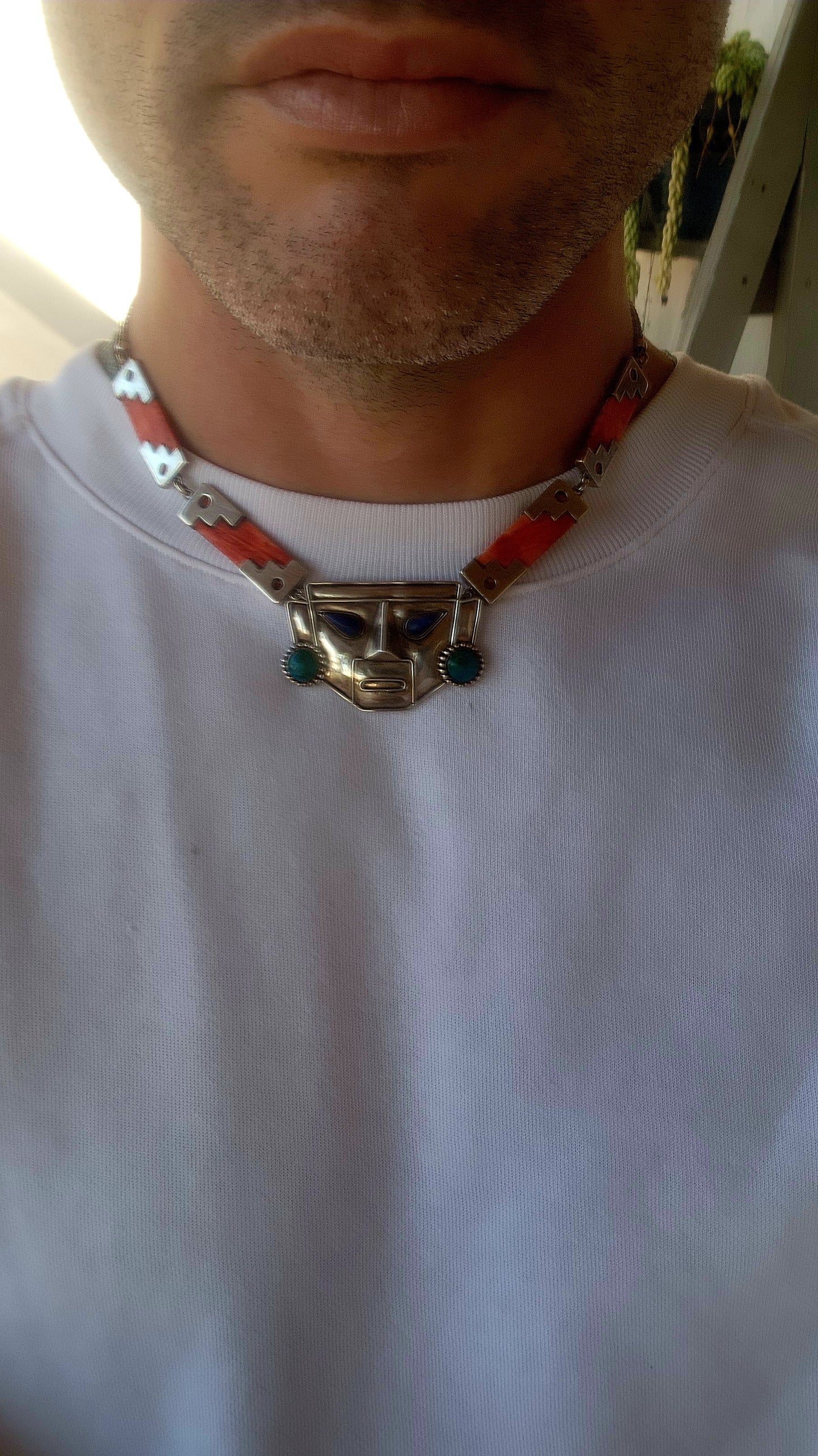 This striking vintage necklace is a true celebration of Andean artistry and cultural symbolism. Crafted in sterling silver, it features a bold central pendant in the form of an Incan-inspired mask.