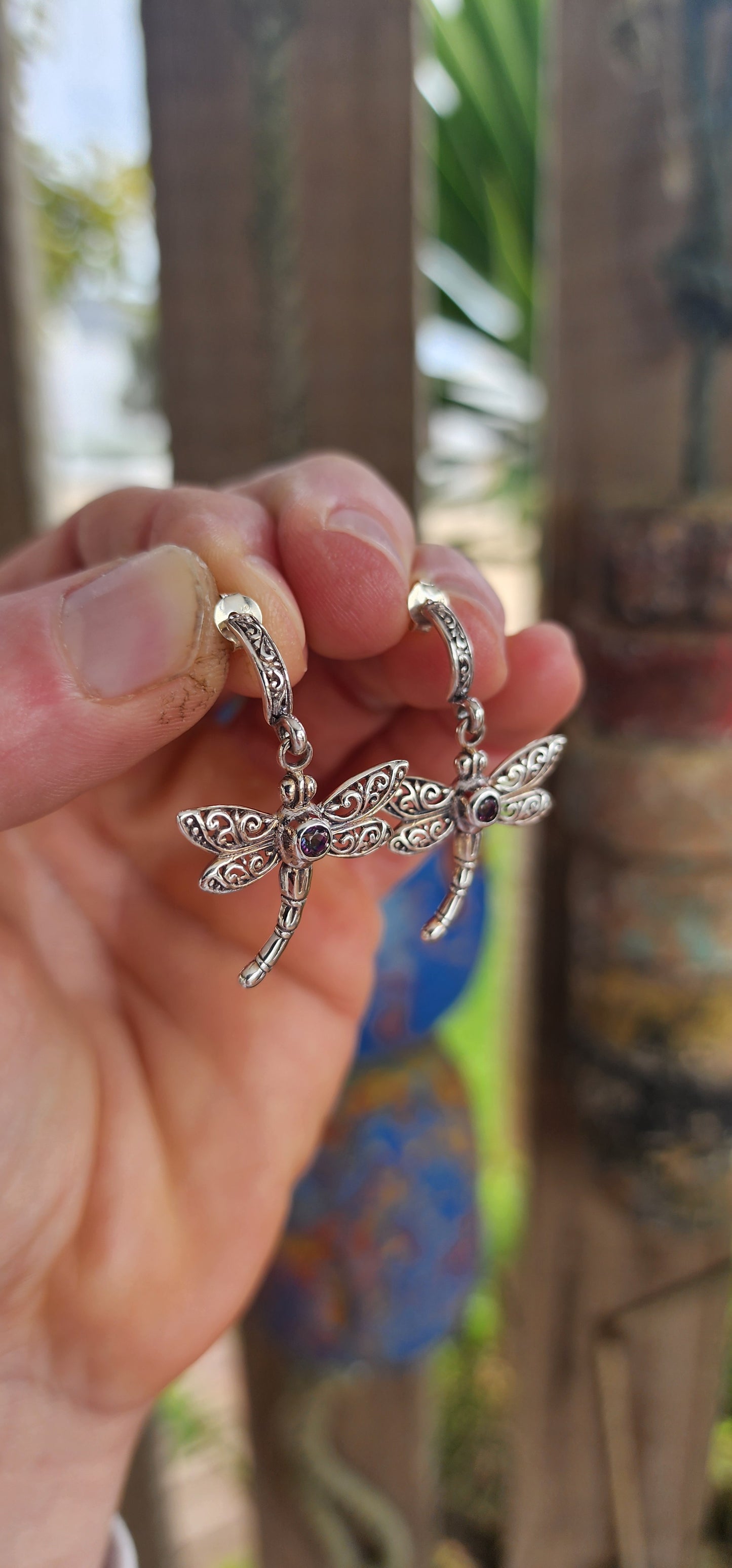 Gracefully suspended in sterling silver, these captivating dragonfly push-in earrings are more than mere adornments — they are talismans of transformation and light.