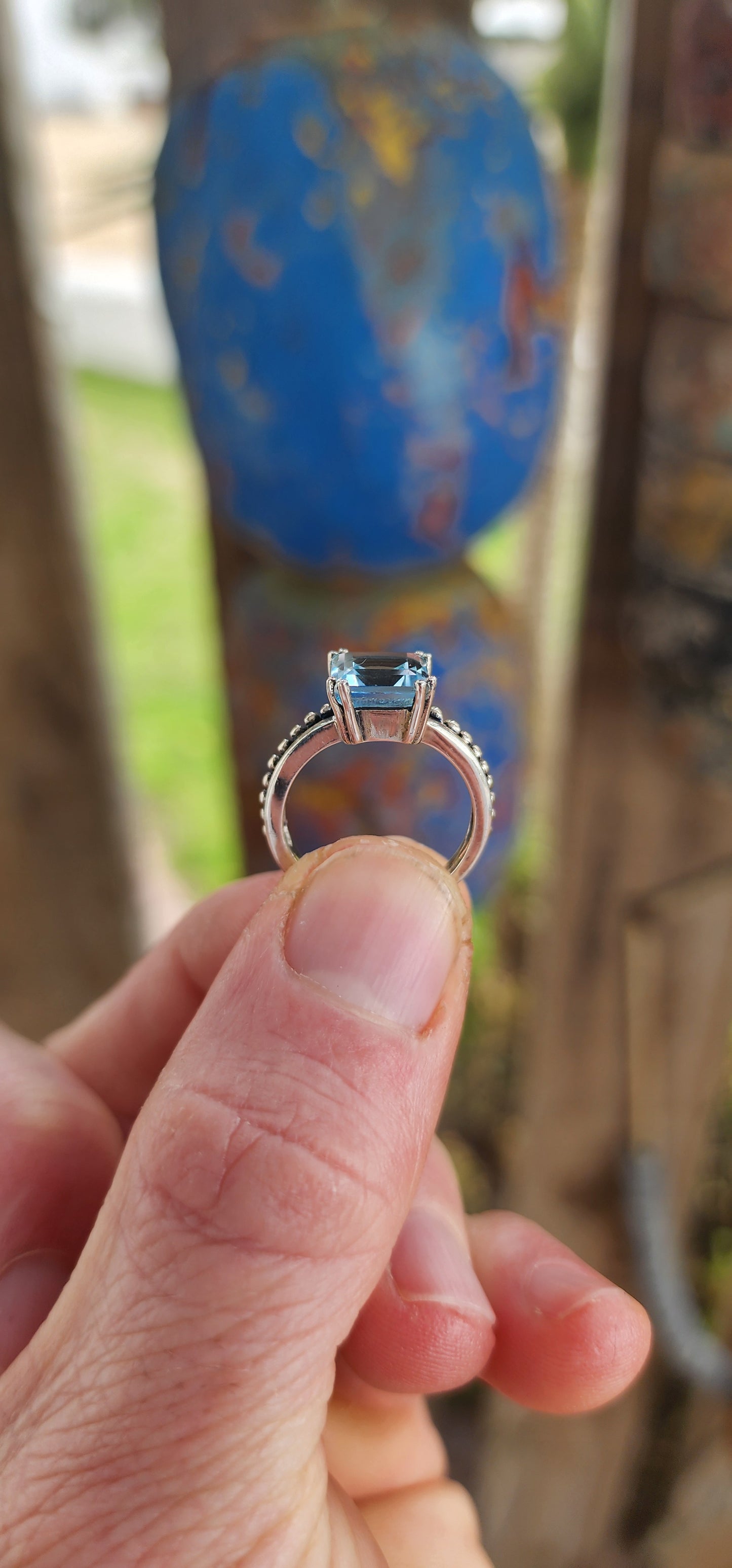 This elegant ring is crafted in polished sterling silver, showcasing a striking solitaire sky blue topaz as its centerpiece.