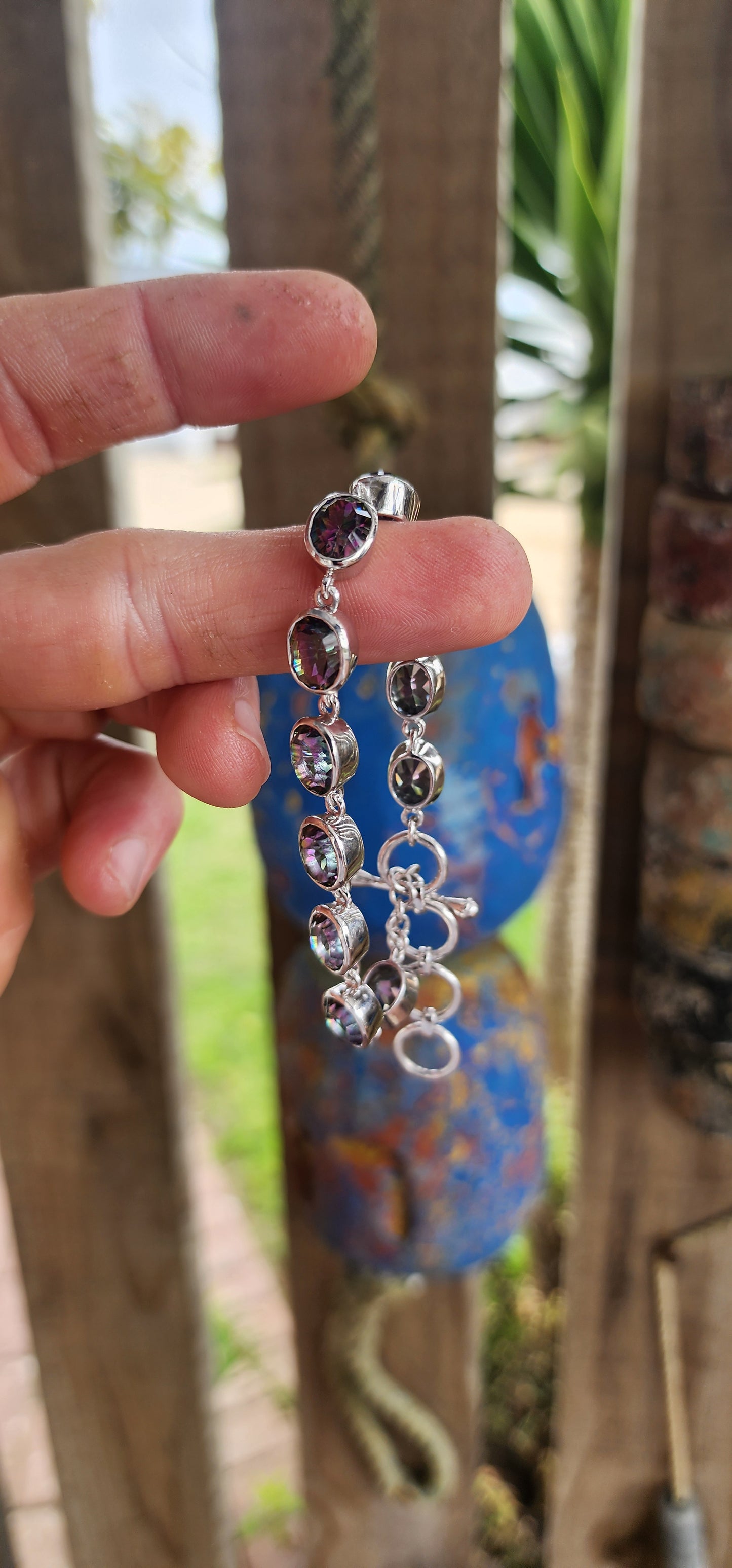 This striking bracelet is crafted in sterling silver in a classic tennis-style design, giving it both elegance and versatility. It features a continuous lineup of 11 generously sized oval-cut Mystic Topaz gemstones.
