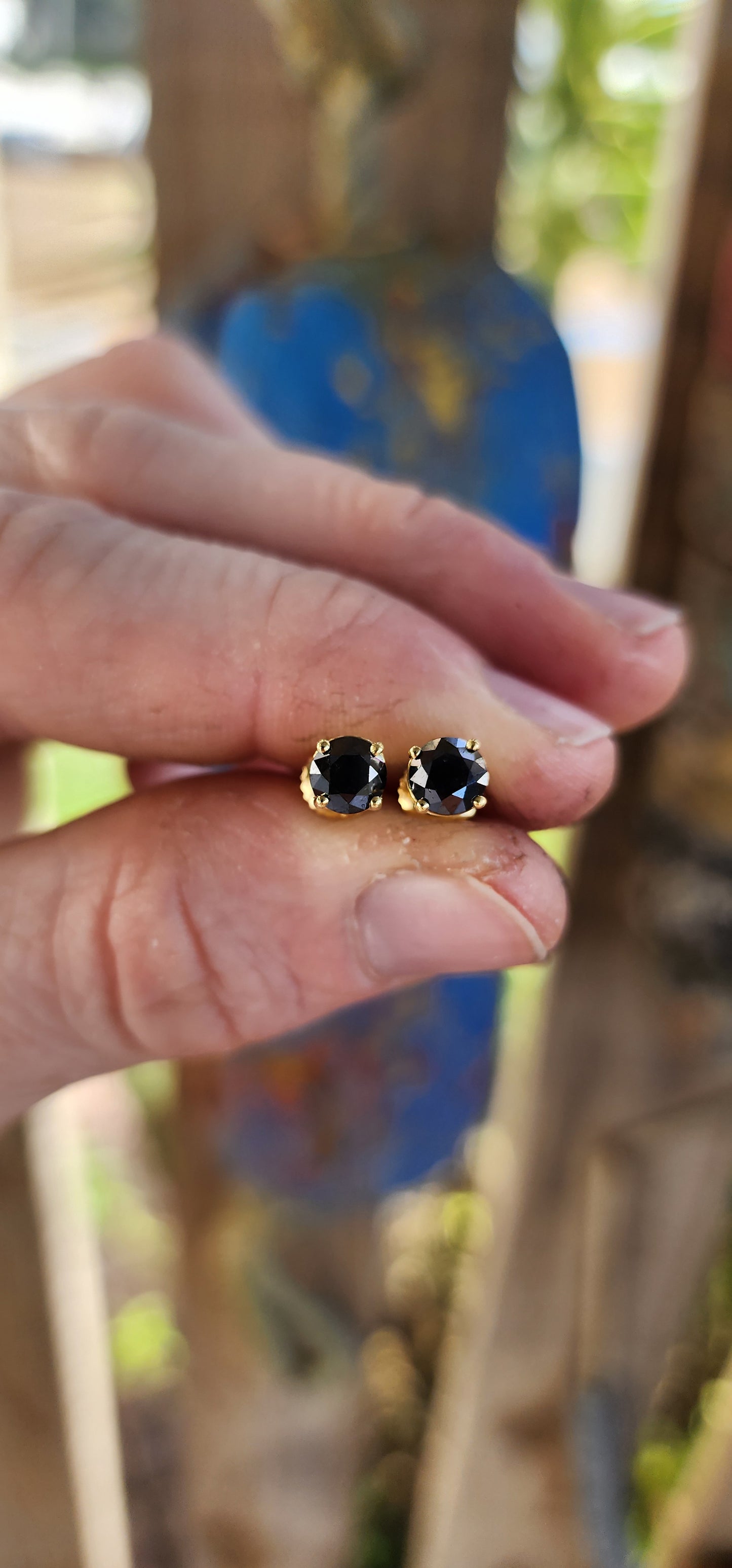 These classical stud earrings, crafted in rich 9ct yellow gold, embody understated sophistication. Each earring showcases a brilliant round-cut black diamond, its mysterious depth echoing the velvet darkness of a starless night.