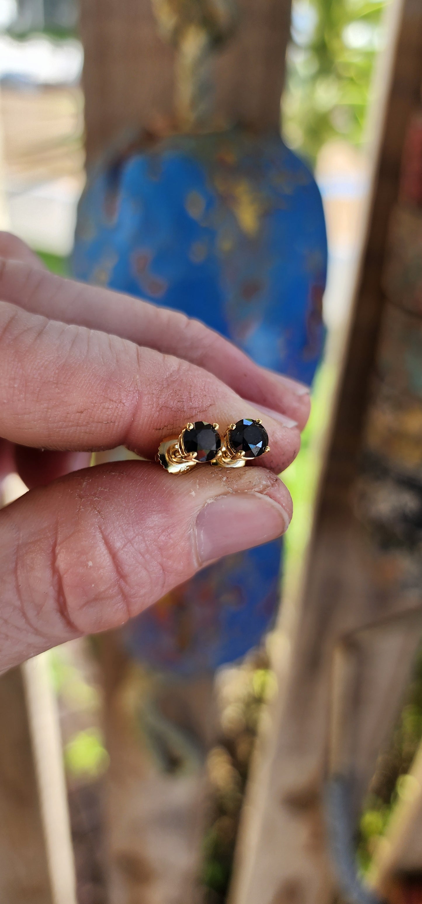 These classical stud earrings, crafted in rich 9ct yellow gold, embody understated sophistication. Each earring showcases a brilliant round-cut black diamond, its mysterious depth echoing the velvet darkness of a starless night.