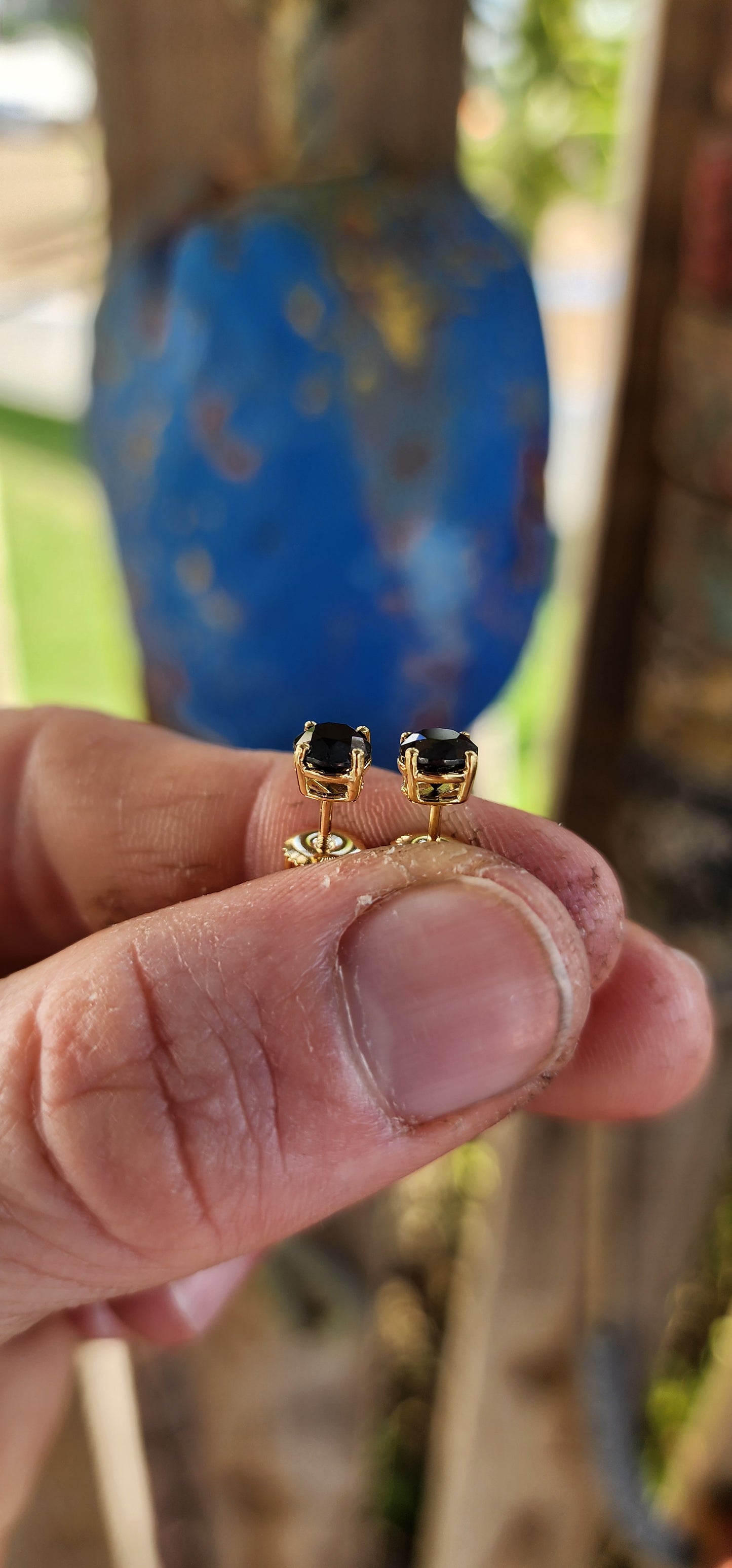 These classical stud earrings, crafted in rich 9ct yellow gold, embody understated sophistication. Each earring showcases a brilliant round-cut black diamond, its mysterious depth echoing the velvet darkness of a starless night.