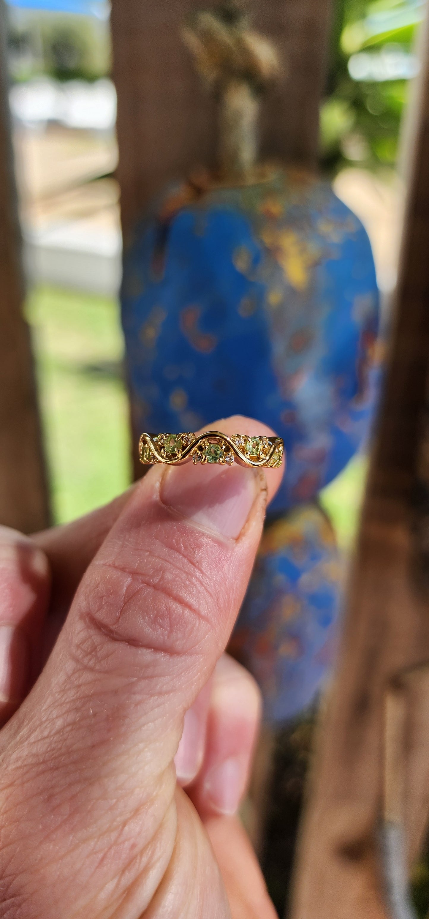 This captivating half-eternity ring is an elegant fusion of fluid design and sunlit vitality, artfully crafted in sterling silver and luxuriously plated in glowing 18ct yellow gold.