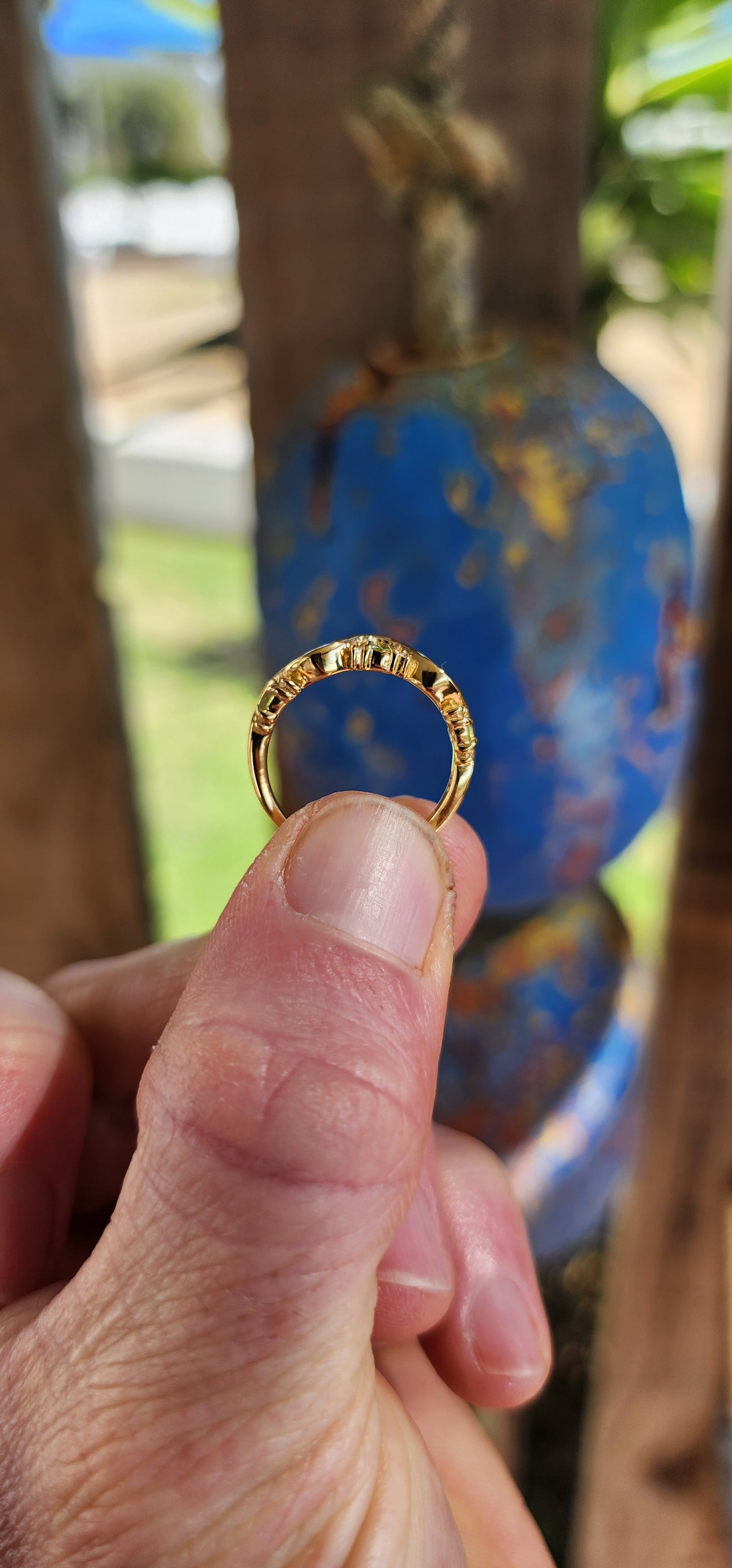 This captivating half-eternity ring is an elegant fusion of fluid design and sunlit vitality, artfully crafted in sterling silver and luxuriously plated in glowing 18ct yellow gold.