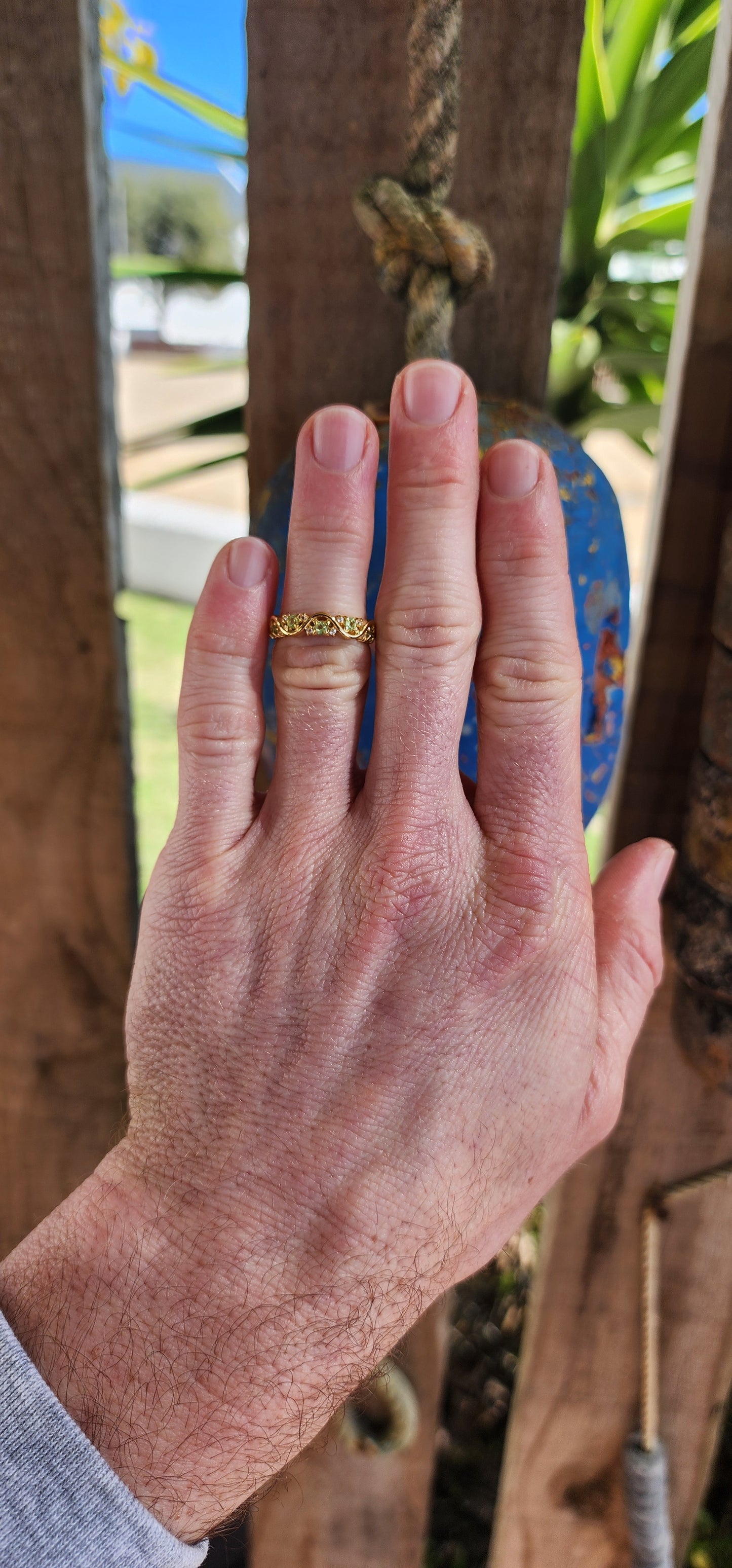 This captivating half-eternity ring is an elegant fusion of fluid design and sunlit vitality, artfully crafted in sterling silver and luxuriously plated in glowing 18ct yellow gold.