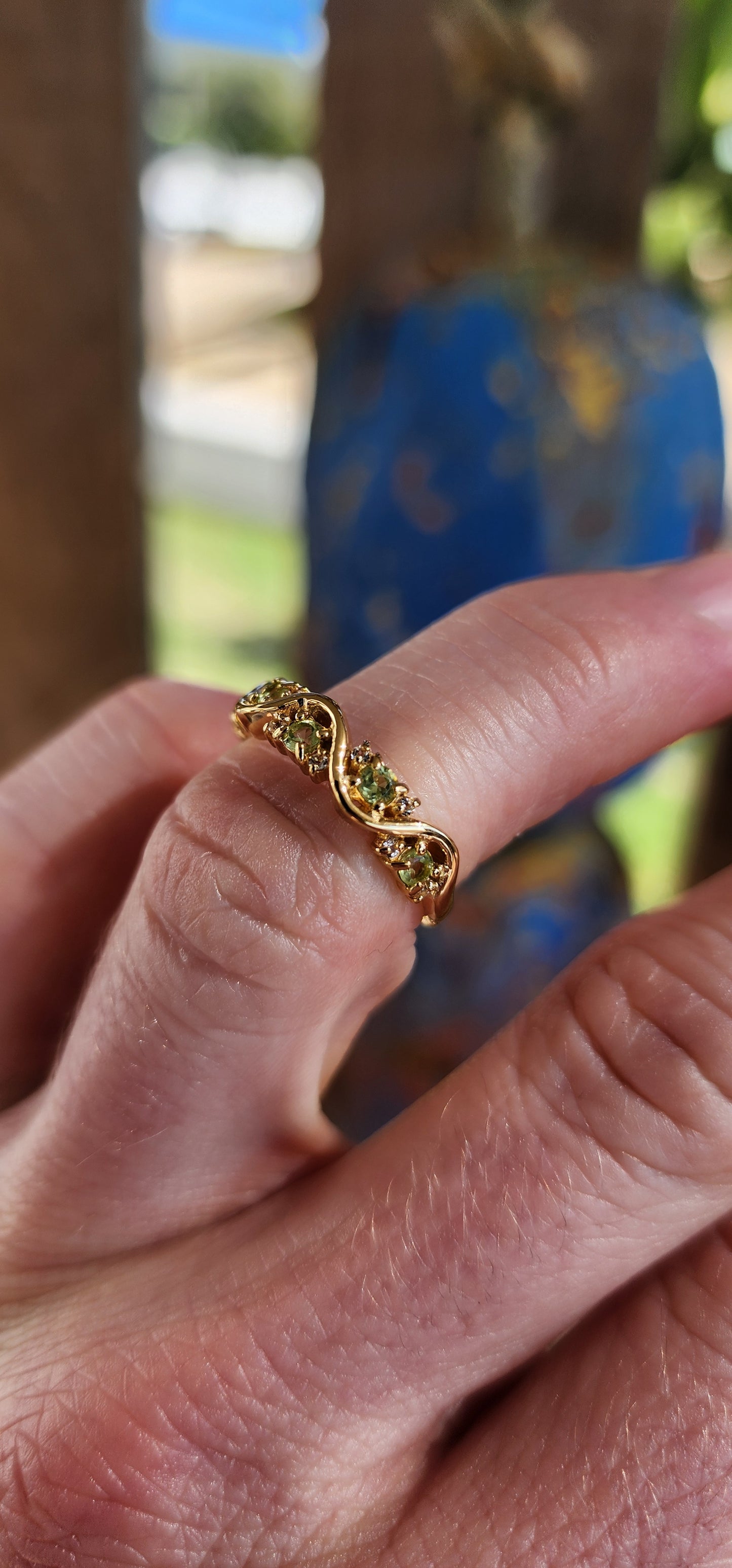 This captivating half-eternity ring is an elegant fusion of fluid design and sunlit vitality, artfully crafted in sterling silver and luxuriously plated in glowing 18ct yellow gold.