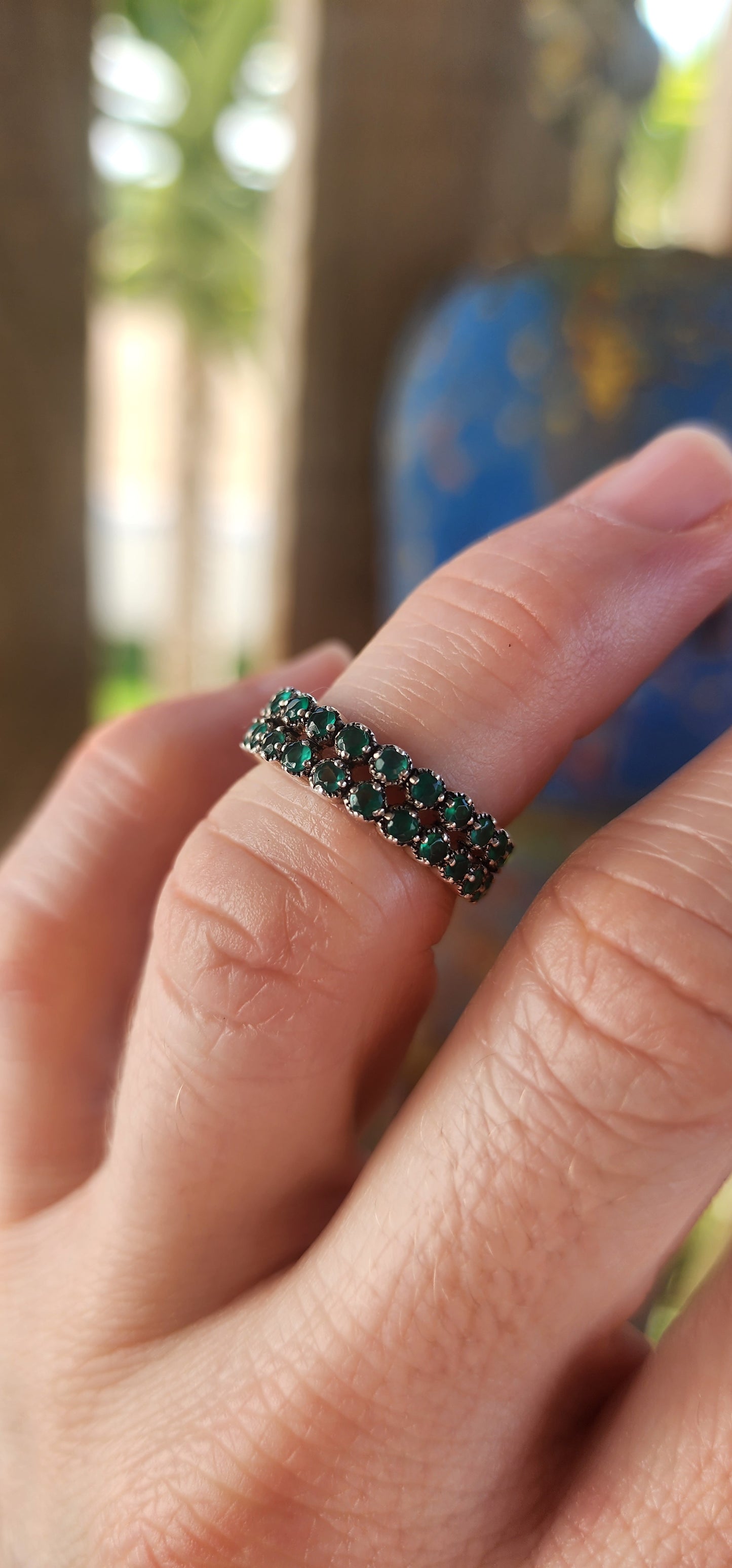 This sterling silver half-eternity ring breathes fresh, verdant energy , set with not one but two shimmering rows of round-cut green chalcedony gemstones.