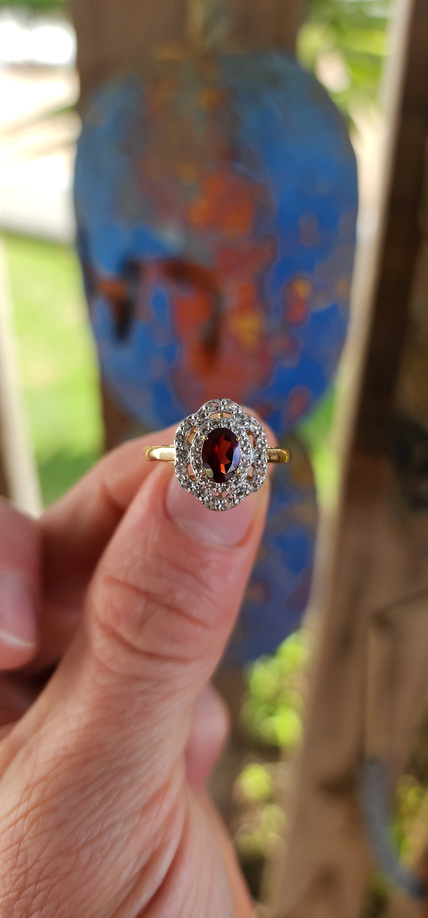 This enchanting vintage style halo ring is expertly crafted in sterling silver and luxuriously finished with a warm layer of 18ct yellow gold plating that lends it a rich and regal glow.