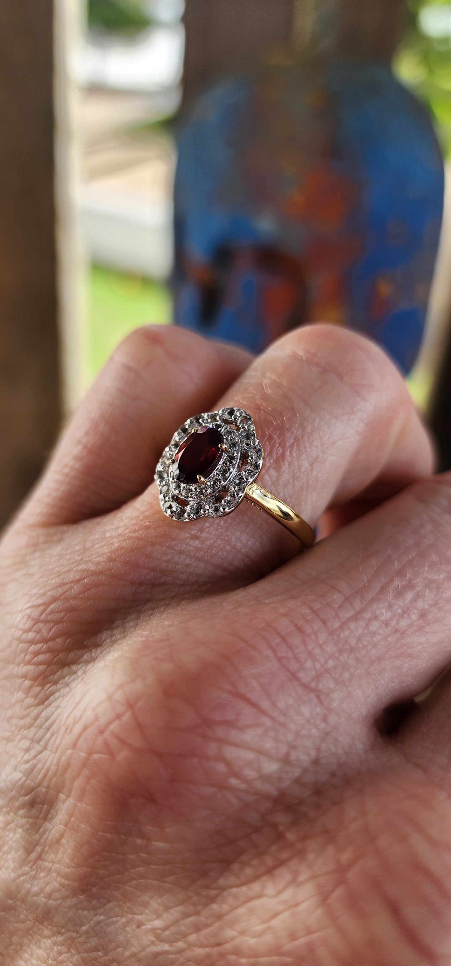 This enchanting vintage style halo ring is expertly crafted in sterling silver and luxuriously finished with a warm layer of 18ct yellow gold plating that lends it a rich and regal glow.