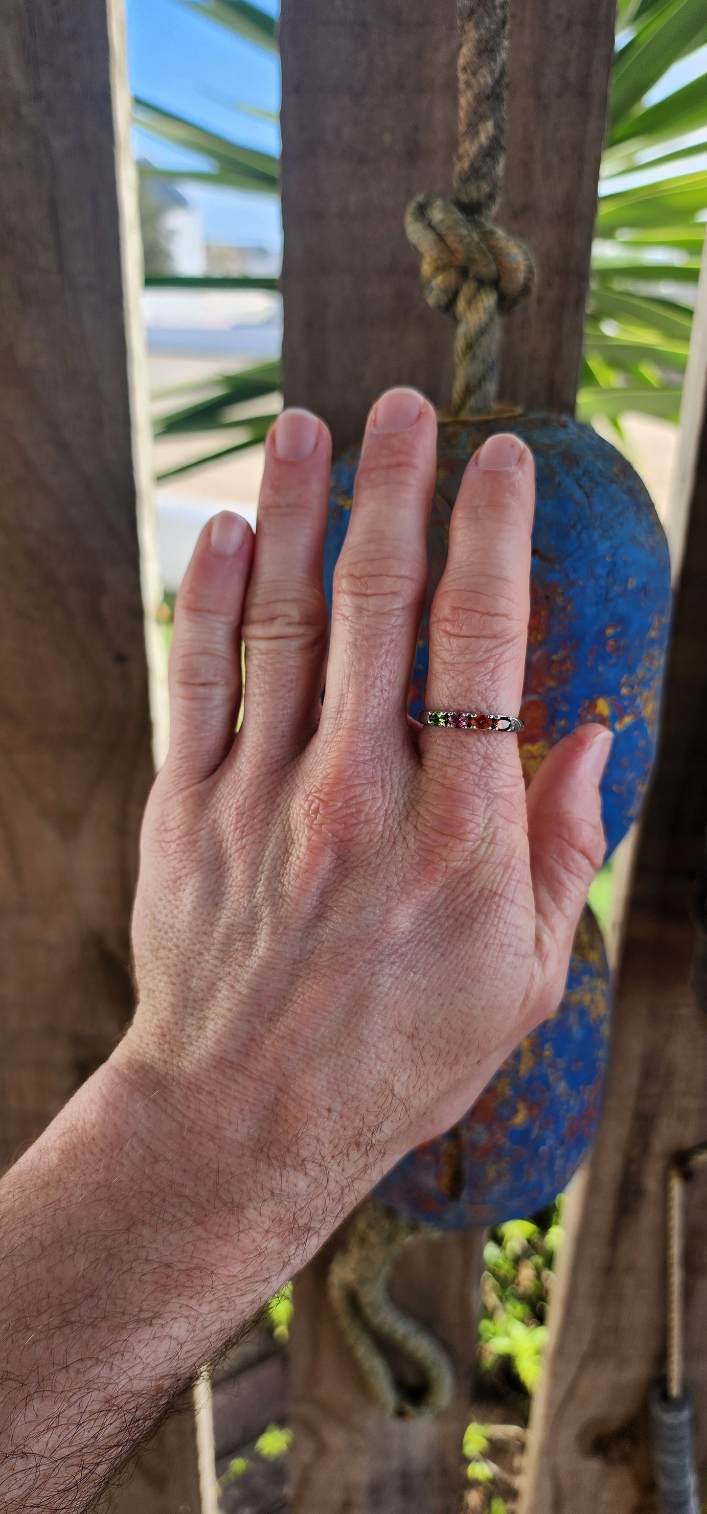 Let your fingers tell a story of color and wonder with this enchanting sterling silver half-eternity ring.