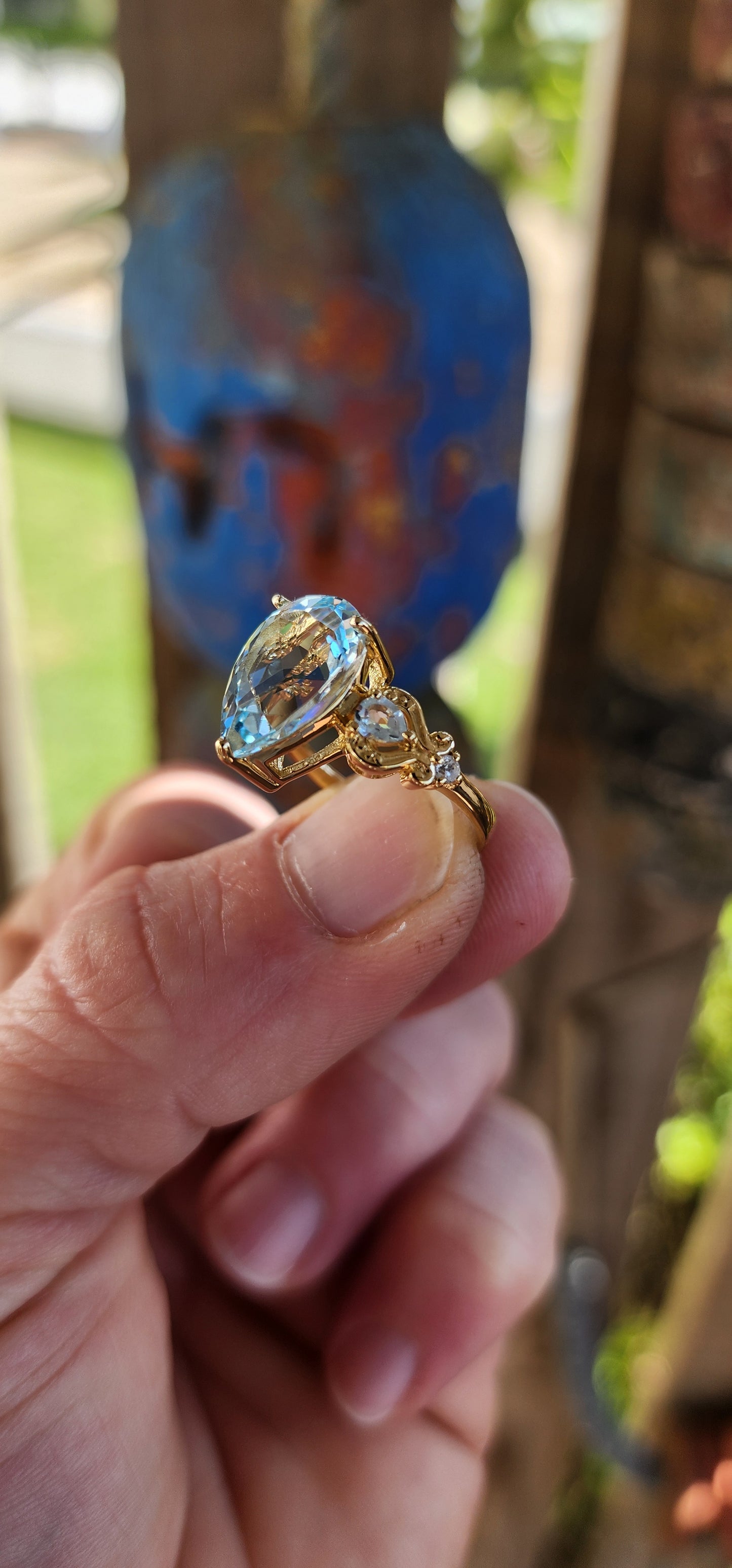Ocean’s Crown – A Sky Blue Topaz Masterpiece.
Kissed by the ocean’s breath and wrapped in golden sunlight—this ring looks as though it was plucked from the treasure chest of a sea-born queen.