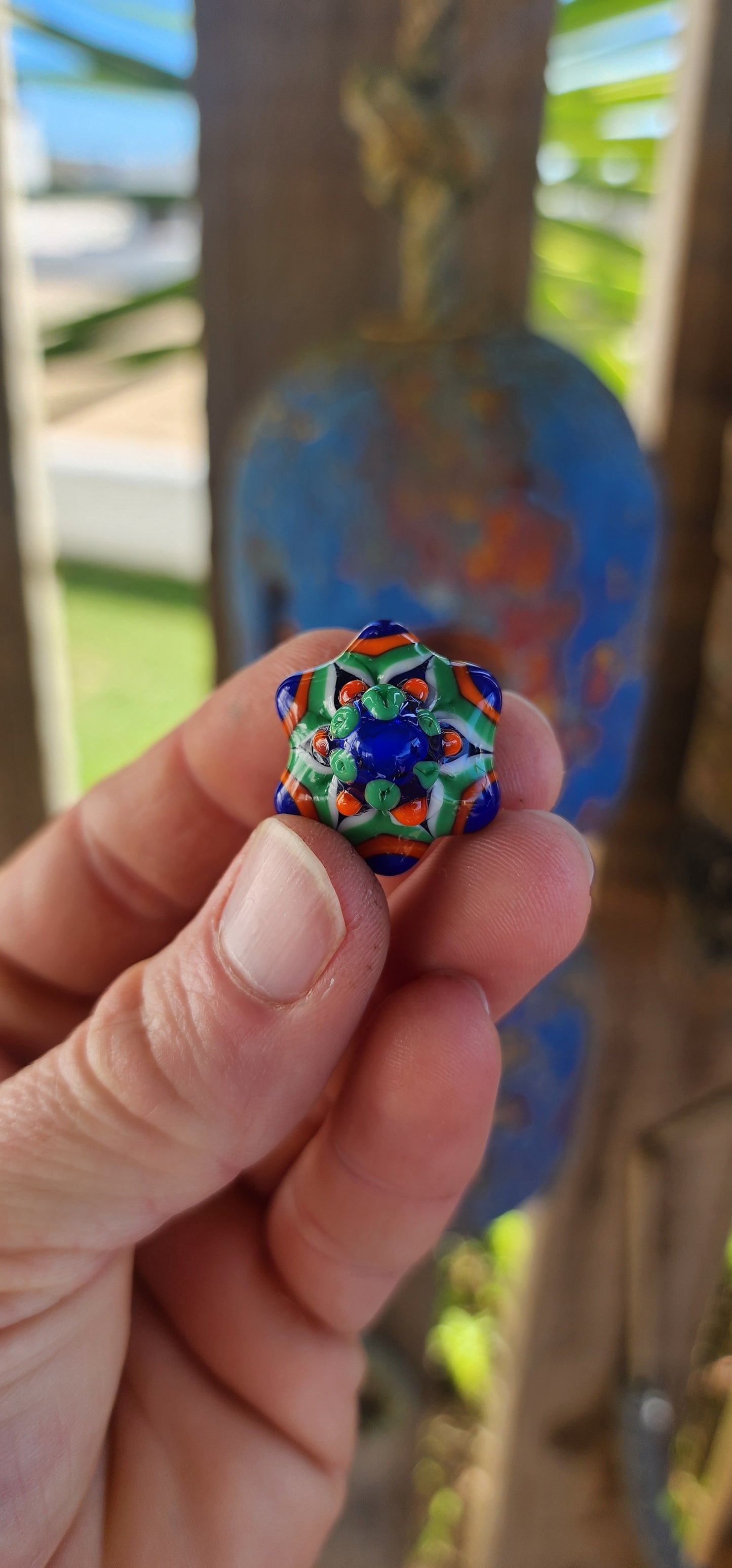 A true burst of color and imagination! This unusual and funky artisan-made pendant has been crafted using the age-old lampwork glass technique, resulting in a miniature piece of wearable art.