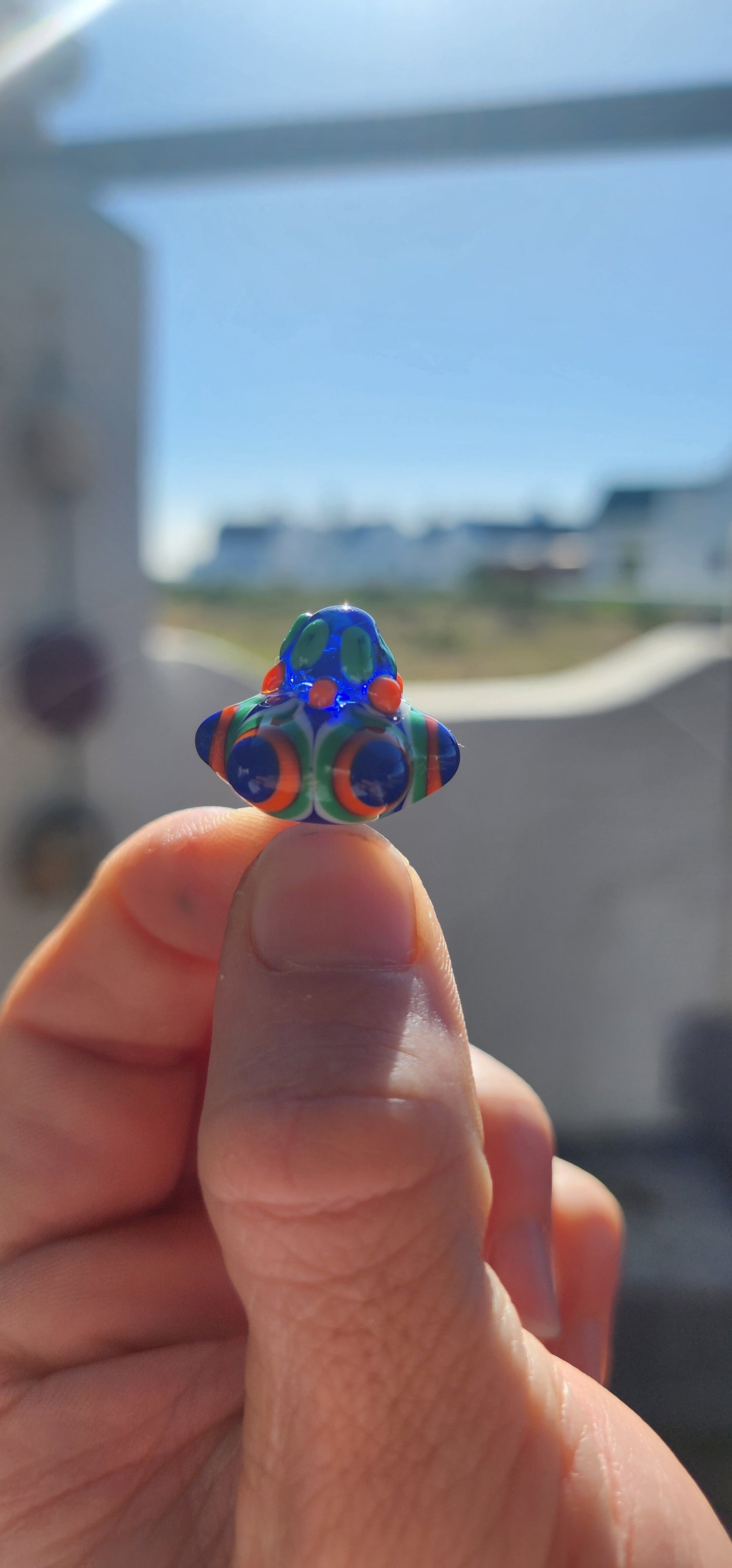 A true burst of color and imagination! This unusual and funky artisan-made pendant has been crafted using the age-old lampwork glass technique, resulting in a miniature piece of wearable art.
