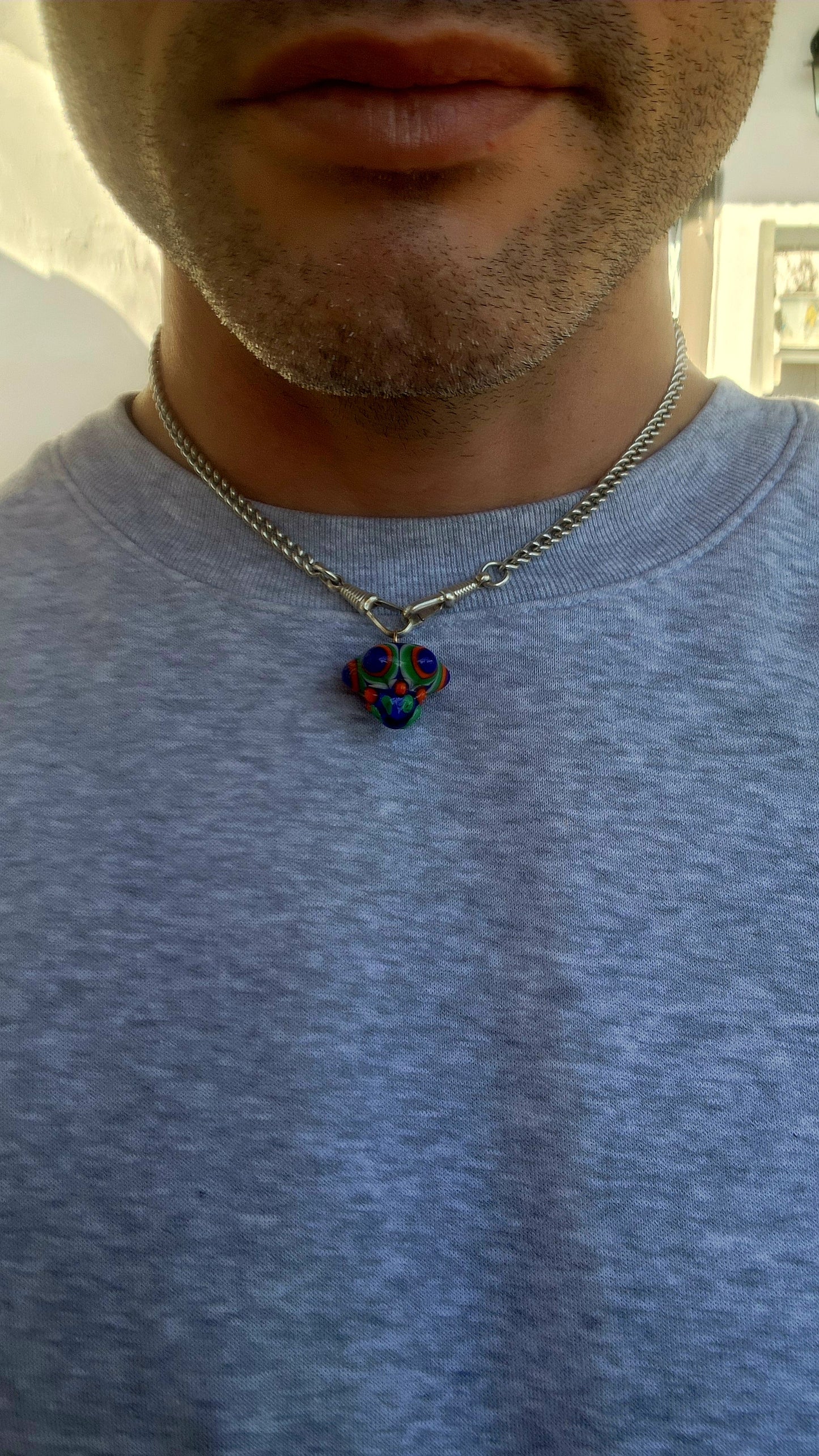 A true burst of color and imagination! This unusual and funky artisan-made pendant has been crafted using the age-old lampwork glass technique, resulting in a miniature piece of wearable art.