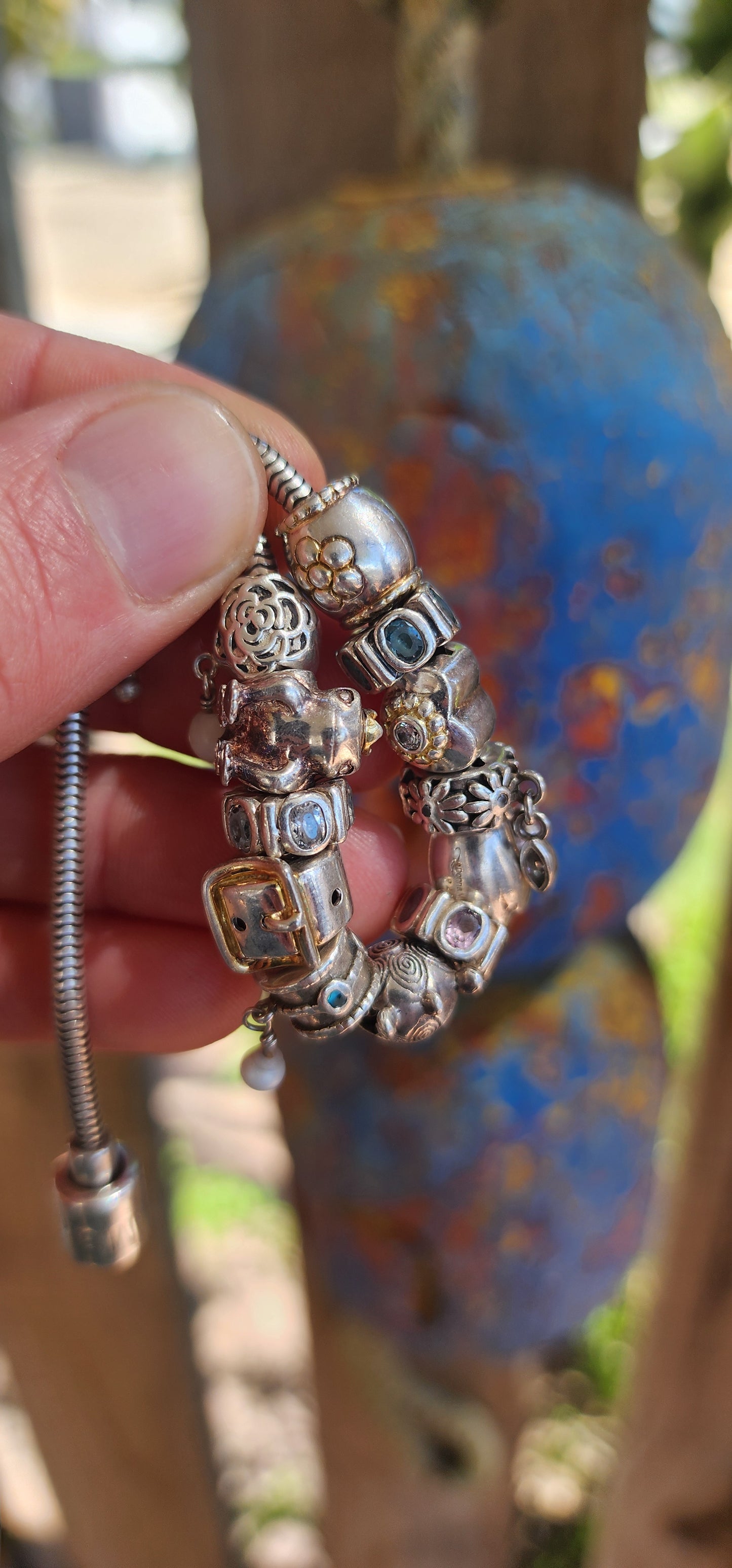 This delightful creation is a designer sterling silver snake chain charm bracelet by Donna Mia, brimming with character, sparkle, and storytelling.