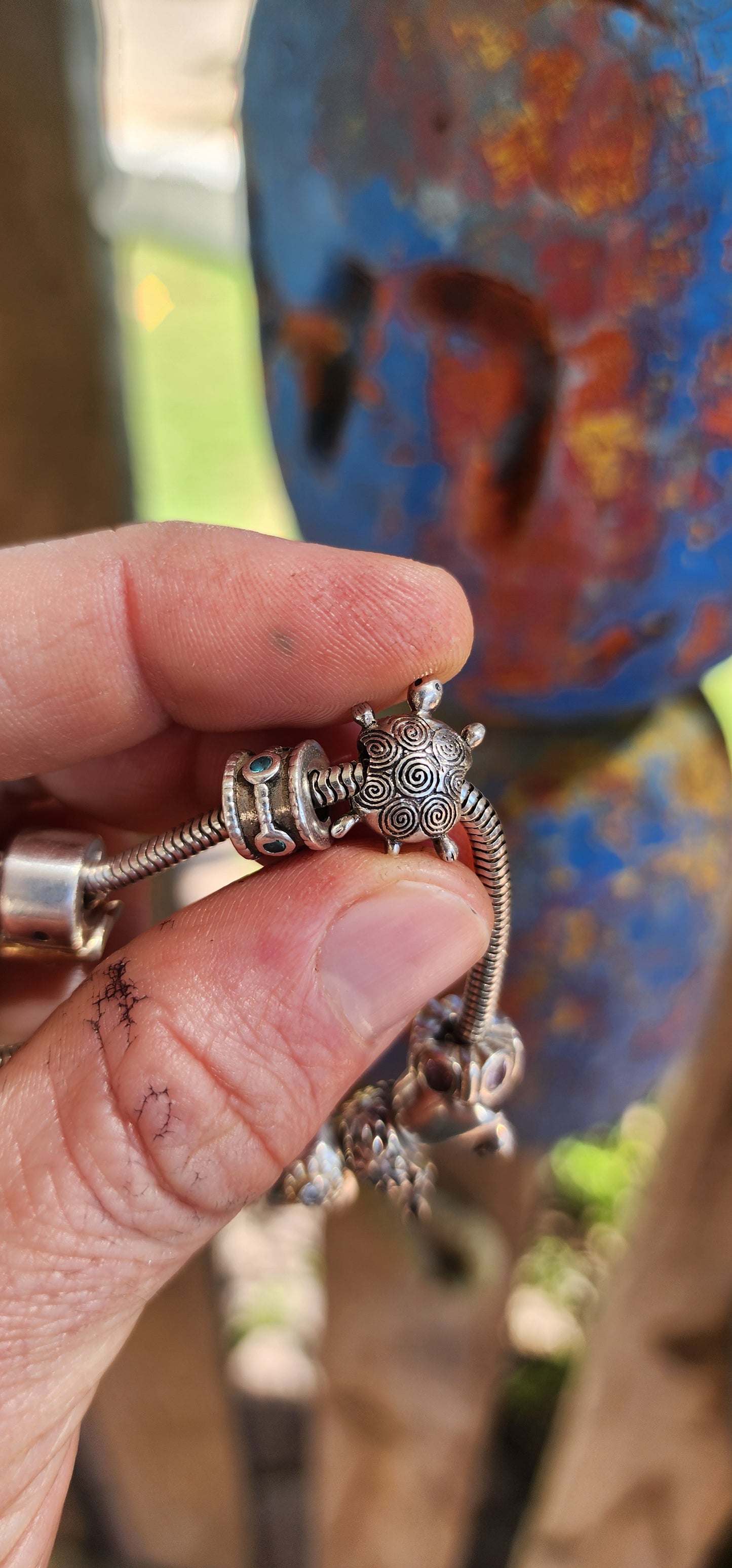 This delightful creation is a designer sterling silver snake chain charm bracelet by Donna Mia, brimming with character, sparkle, and storytelling.