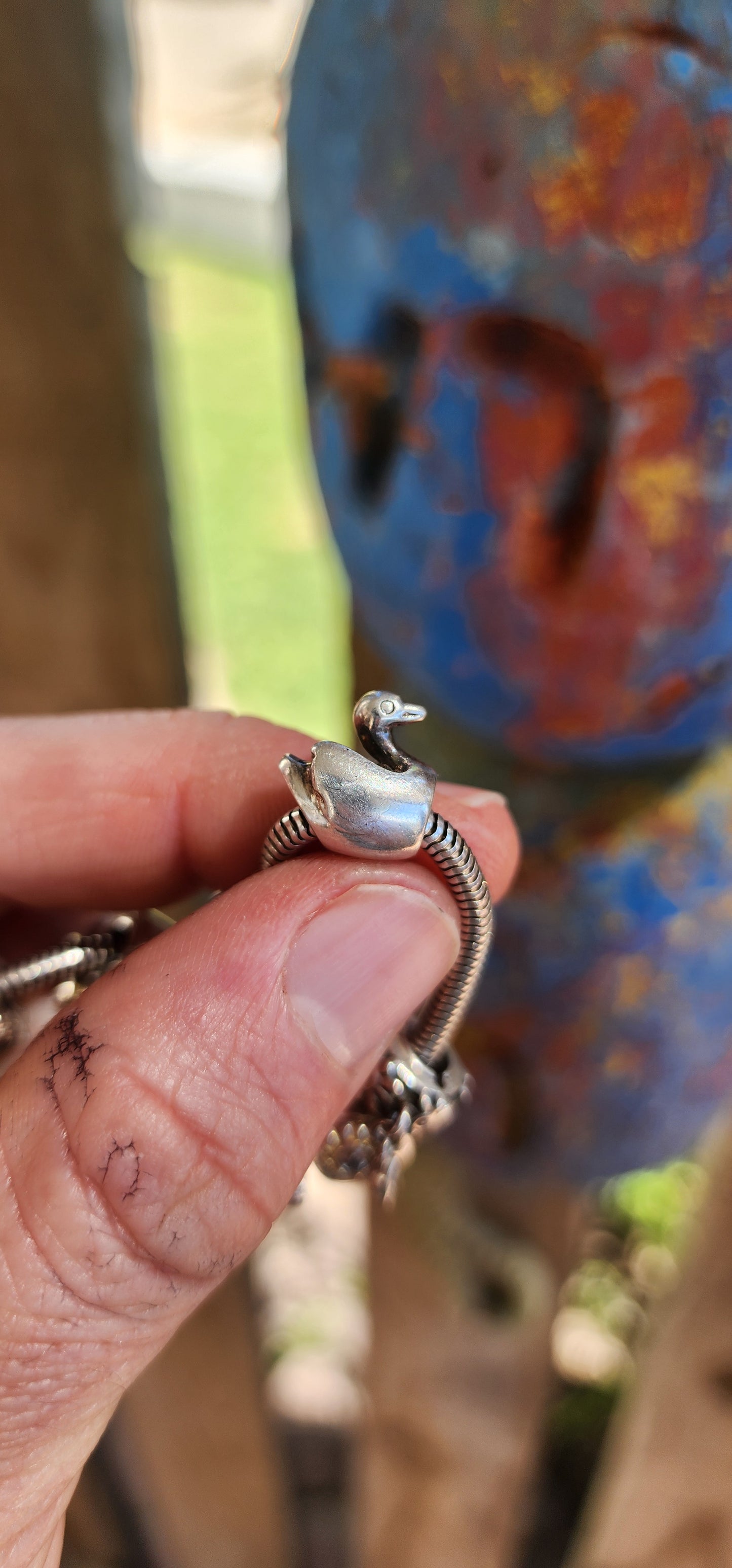 This delightful creation is a designer sterling silver snake chain charm bracelet by Donna Mia, brimming with character, sparkle, and storytelling.
