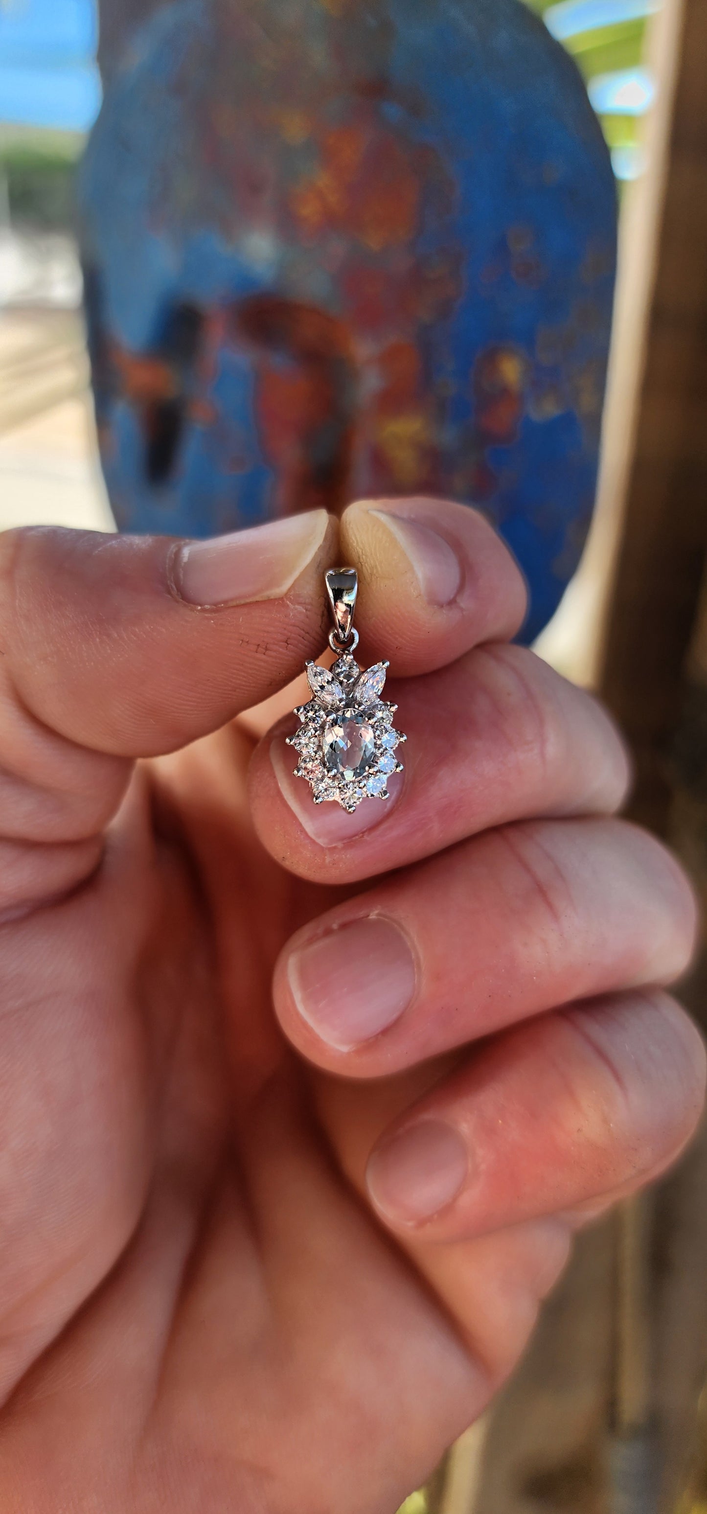 An enchanting treasure of elegance – this sterling silver and aquamarine floral halo pendant perfectly captures the essence of grace.