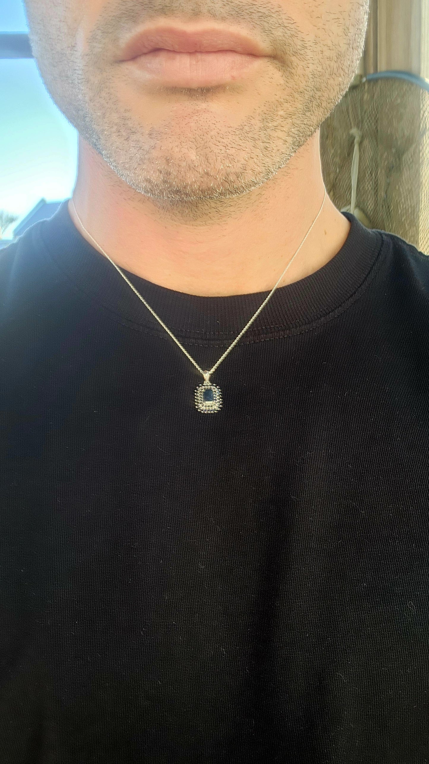 Elegant and timeless, this pendant features a richly saturated emerald-cut deep blue sapphire as its centerpiece, prong-set to capture and reflect light with depth and intensity.