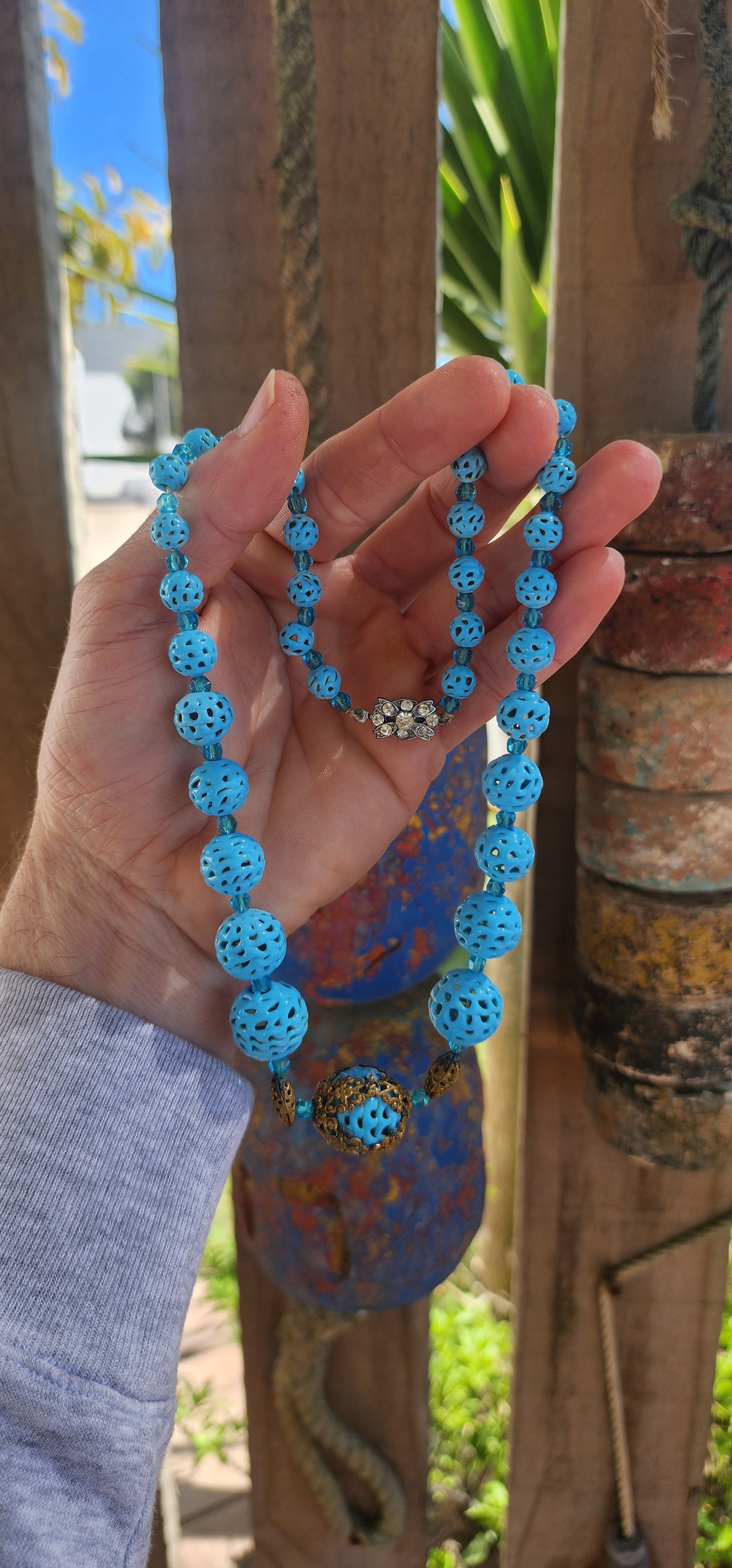 A marvelous survivor from the 1920s Art Deco era, this necklace is strung with a sequence of delicate hand-spun pierced lampwork beads in the most striking baby blue.