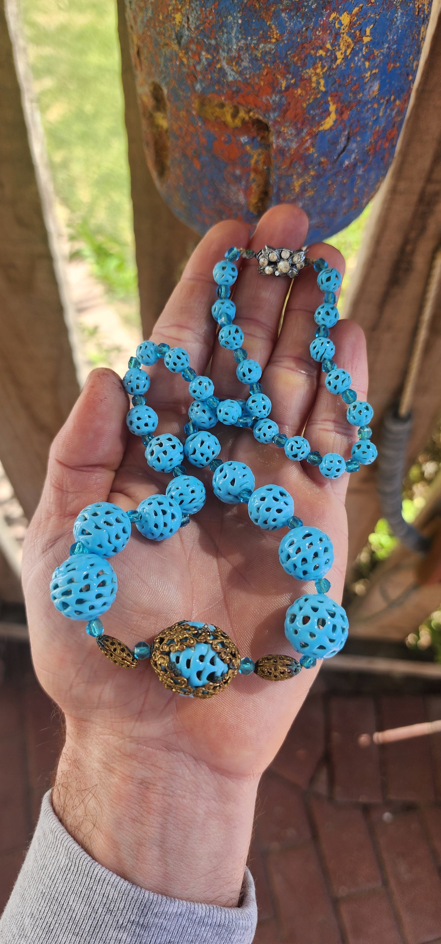 A marvelous survivor from the 1920s Art Deco era, this necklace is strung with a sequence of delicate hand-spun pierced lampwork beads in the most striking baby blue.
