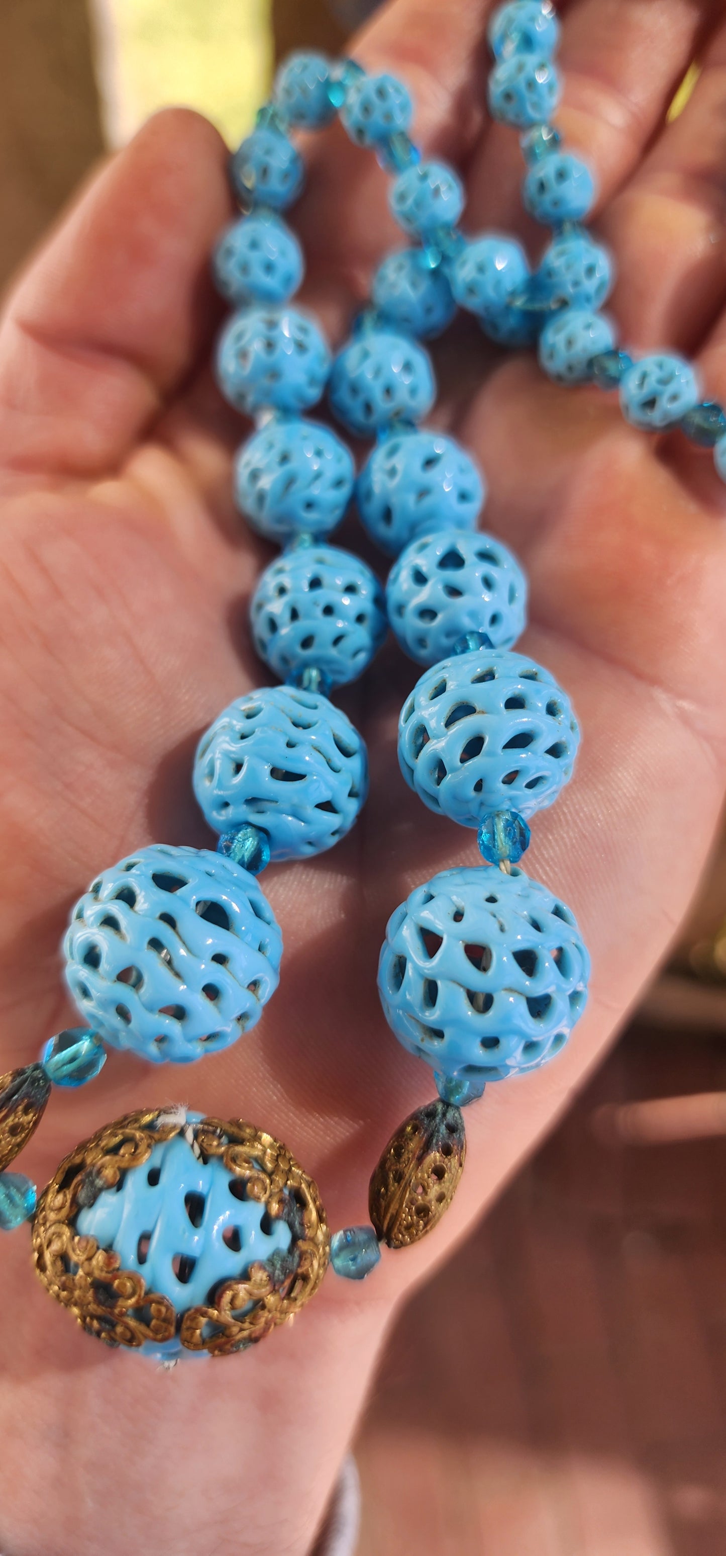 A marvelous survivor from the 1920s Art Deco era, this necklace is strung with a sequence of delicate hand-spun pierced lampwork beads in the most striking baby blue.