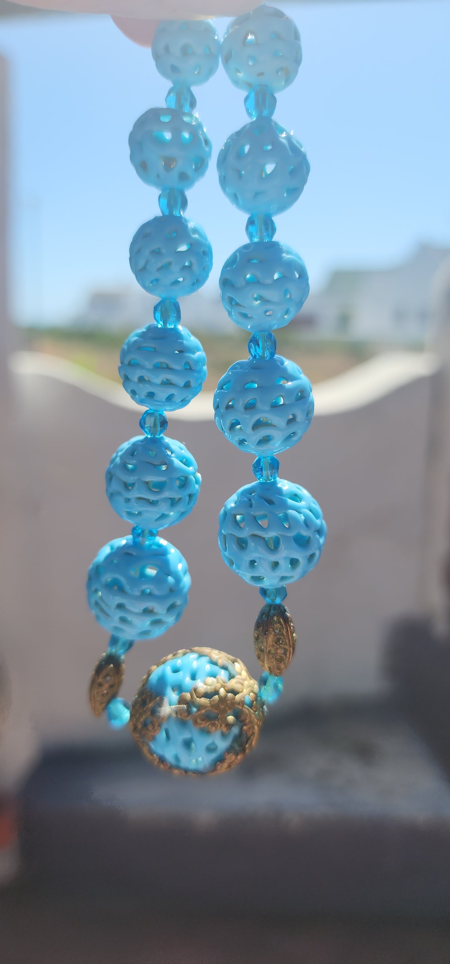 A marvelous survivor from the 1920s Art Deco era, this necklace is strung with a sequence of delicate hand-spun pierced lampwork beads in the most striking baby blue.