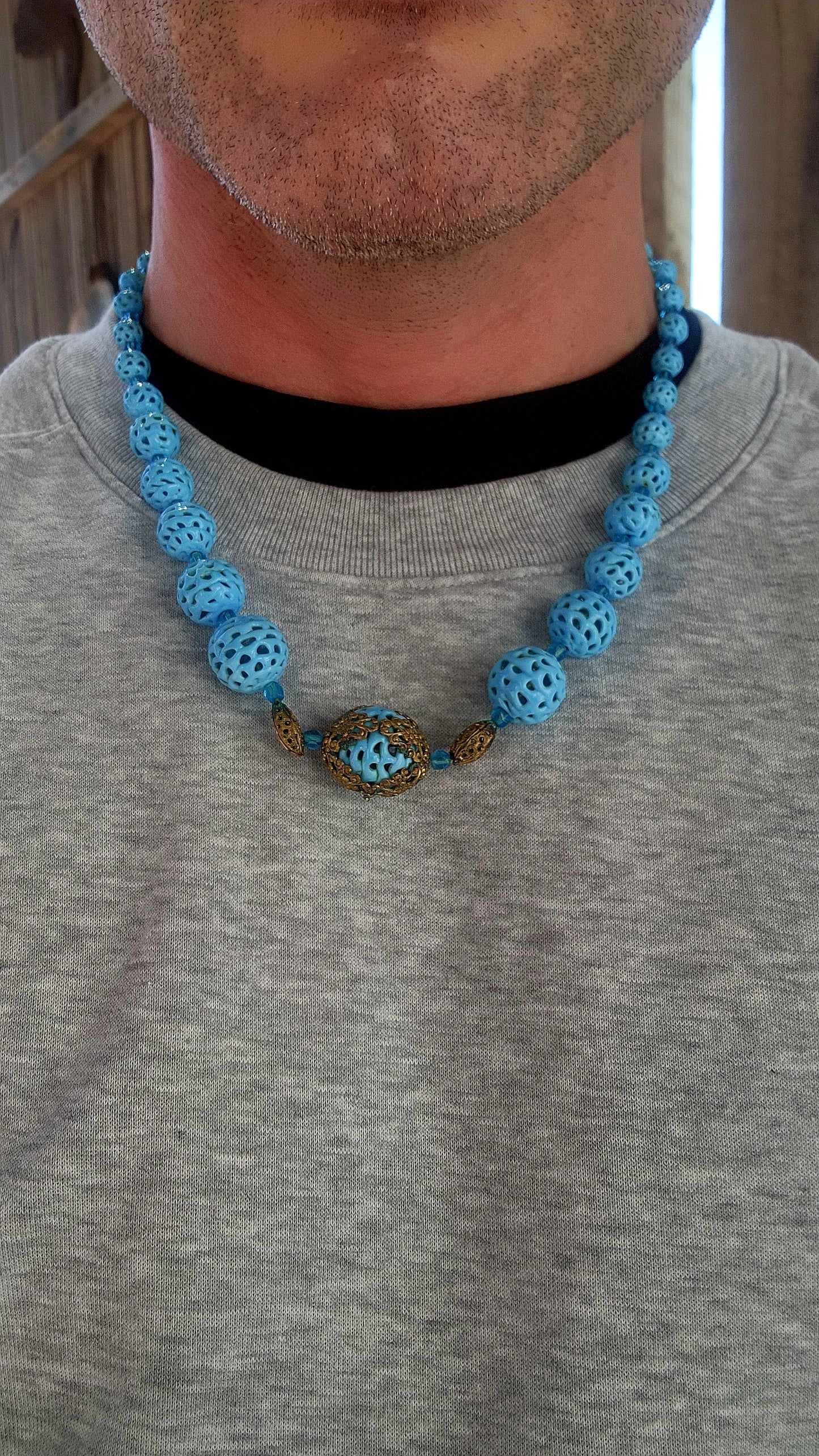 A marvelous survivor from the 1920s Art Deco era, this necklace is strung with a sequence of delicate hand-spun pierced lampwork beads in the most striking baby blue.