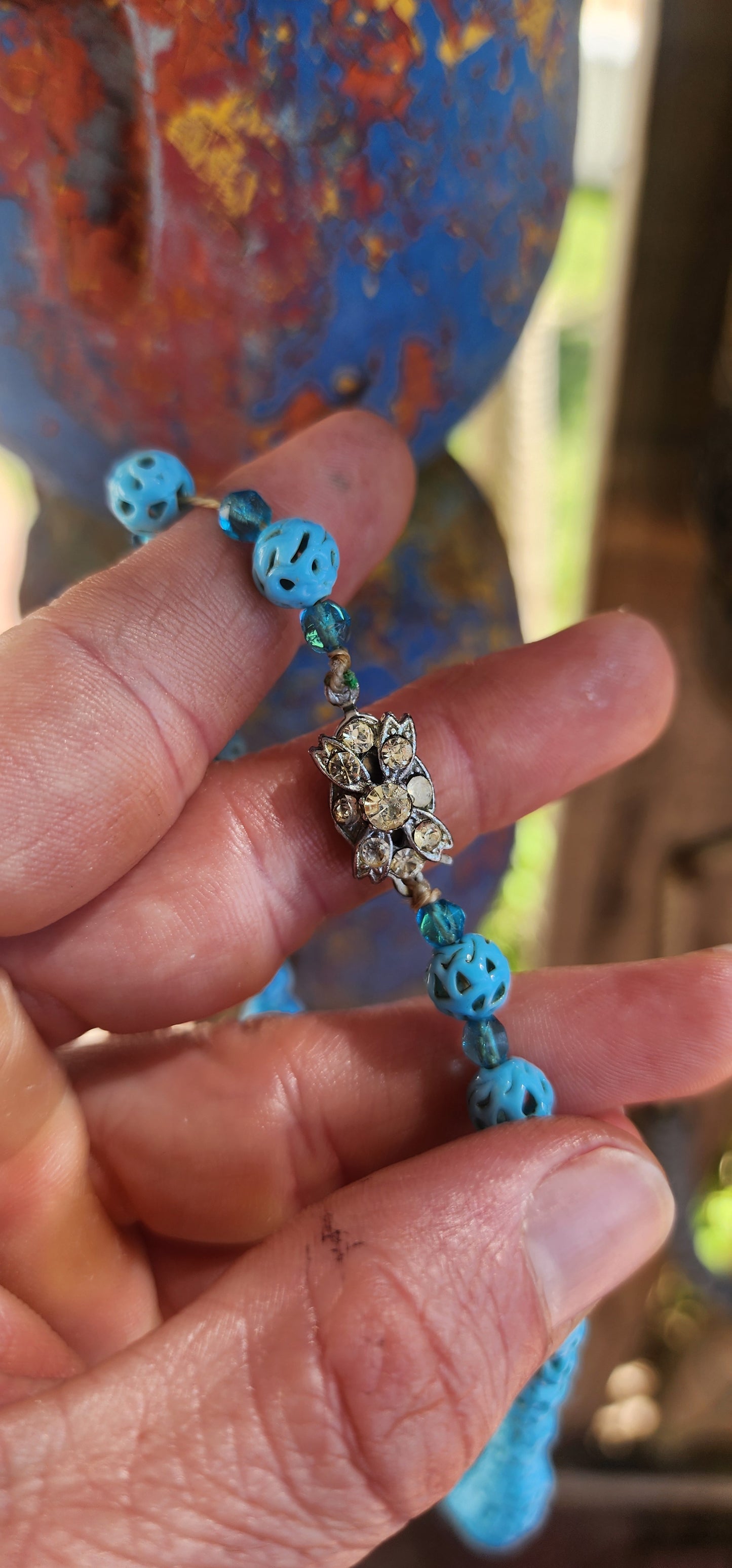 A marvelous survivor from the 1920s Art Deco era, this necklace is strung with a sequence of delicate hand-spun pierced lampwork beads in the most striking baby blue.