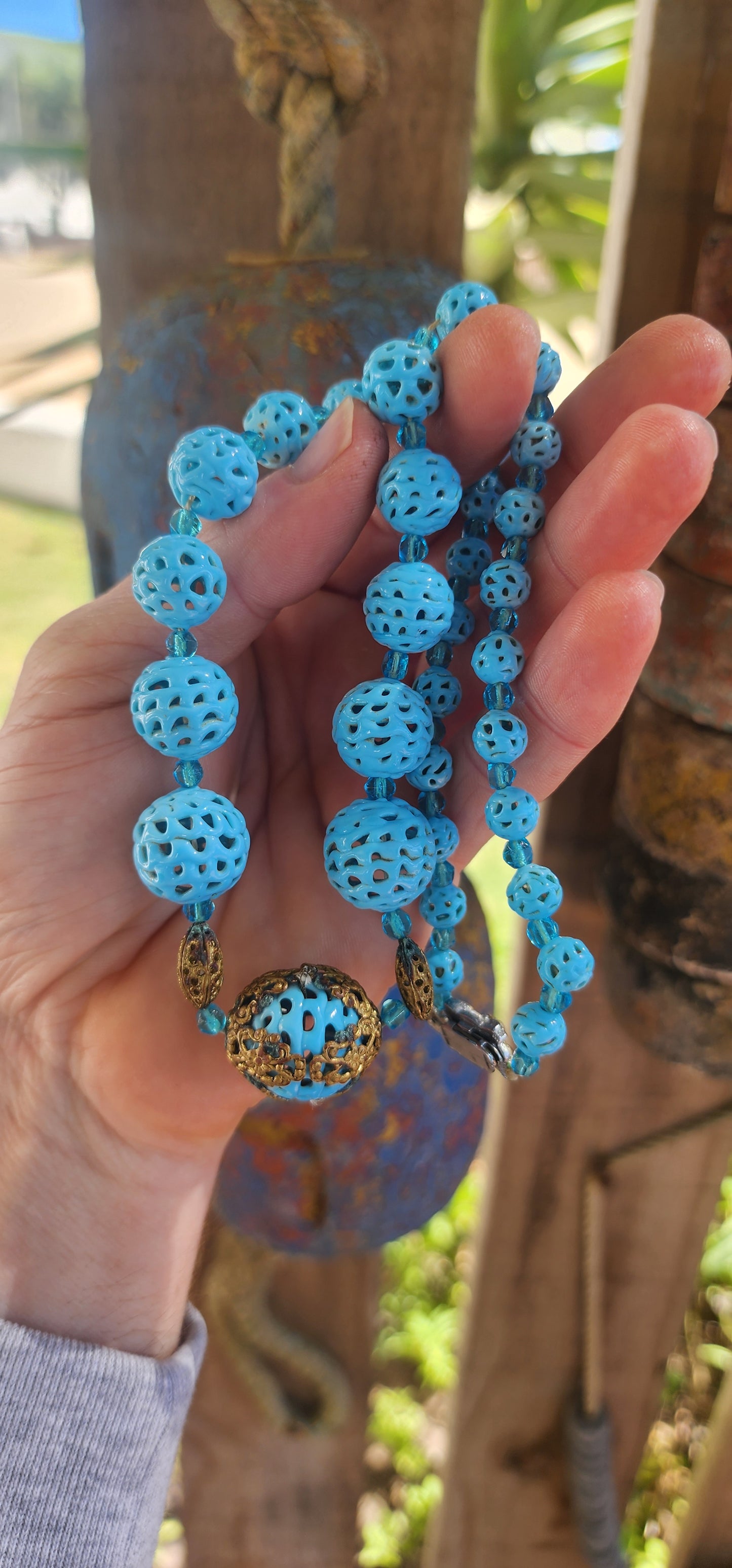 A marvelous survivor from the 1920s Art Deco era, this necklace is strung with a sequence of delicate hand-spun pierced lampwork beads in the most striking baby blue.